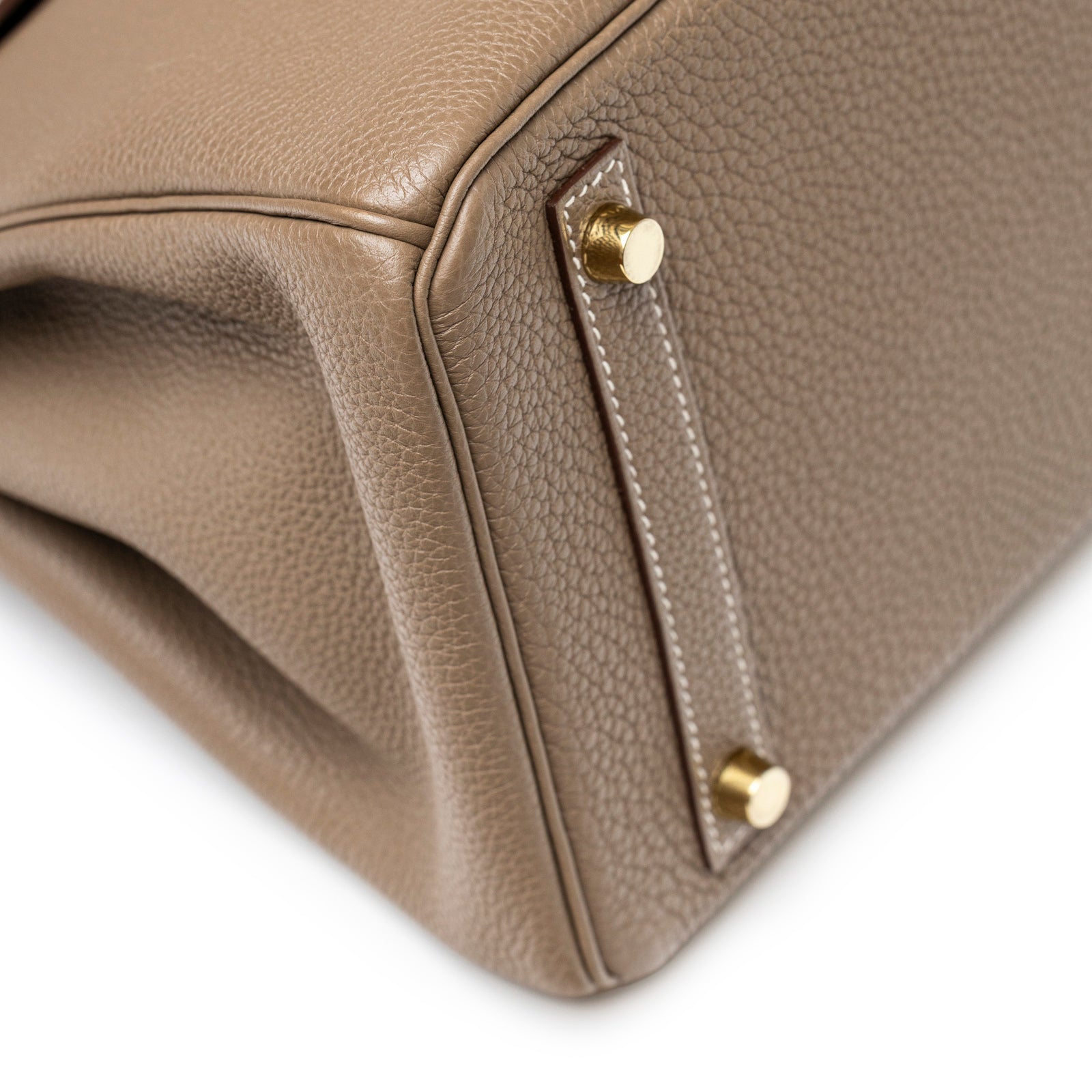 Close-up of bottom corner showing gold hardware and pebbled texture on Hermès Birkin 30 Etoupe Togo Gold Hardware