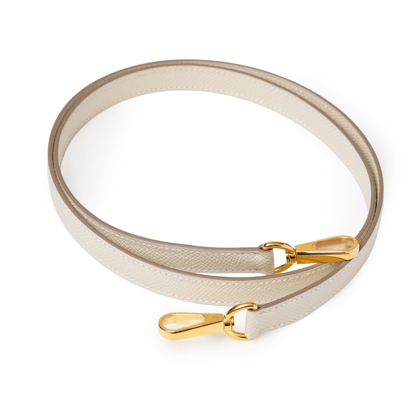 Close-up angled view of Hermès Mini Evelyne Sellier Craie Epsom Gold Hardware detachable shoulder strap