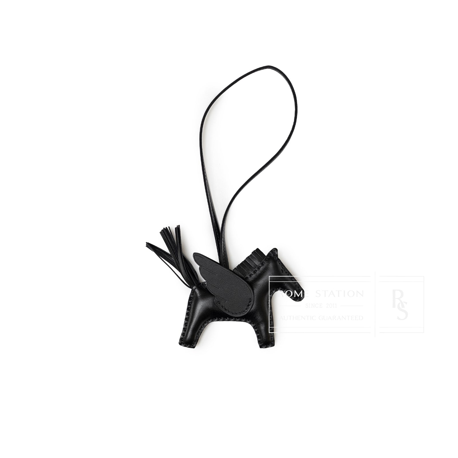 Top-down view of Hermès Rodeo Pegase Bag Charm PM So Black leather horse with loop strap and detailed stitching