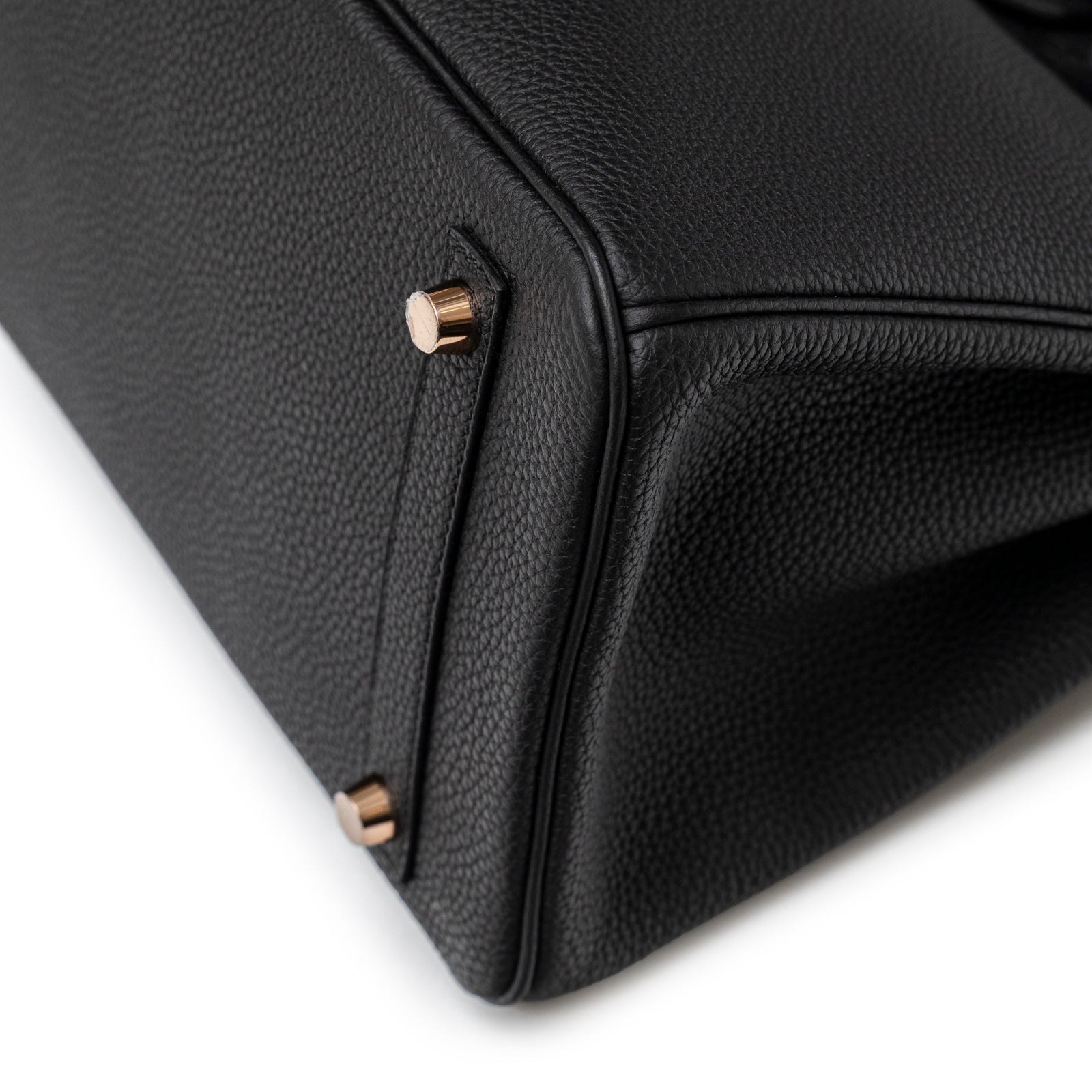 Close-up angled view of Hermès Birkin 30 Black Togo Rose Gold Hardware showing bottom corner and feet details