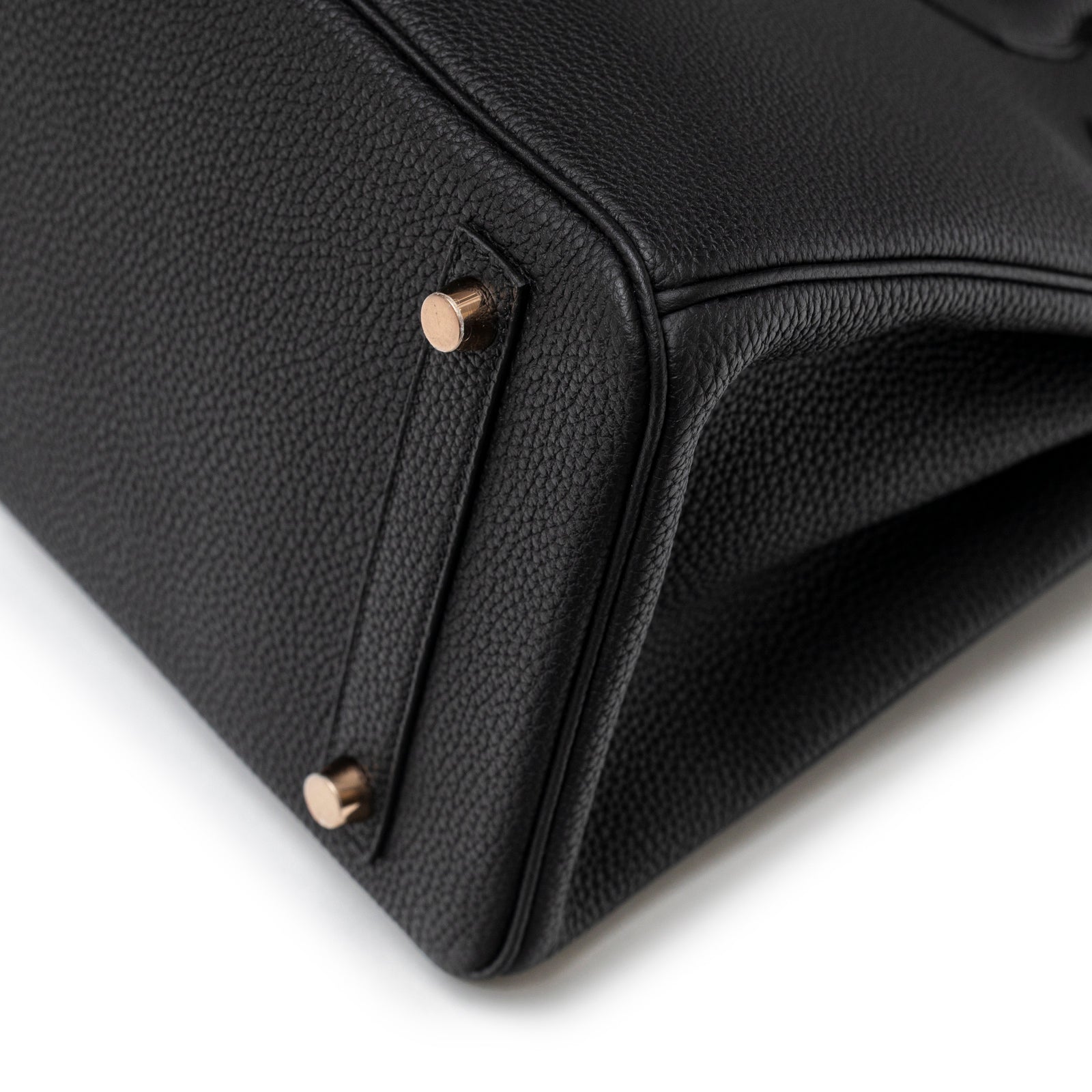 Close-up angled view of base and rose gold hardware studs on Hermès Birkin 30 Black Togo Rose Gold Hardware