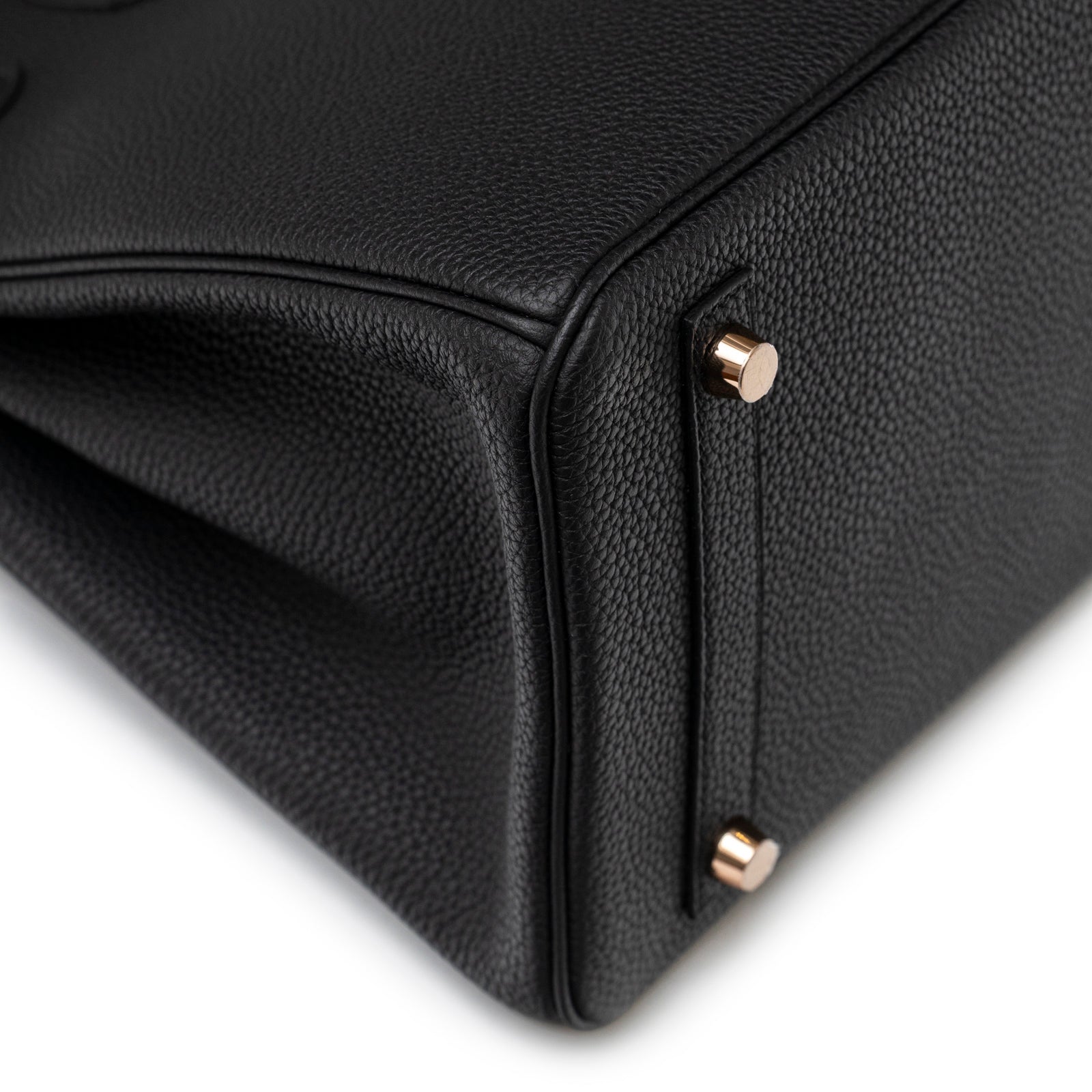 Close-up angled view of Hermès Birkin 30 Black Togo Rose Gold Hardware showing base corner and feet detail
