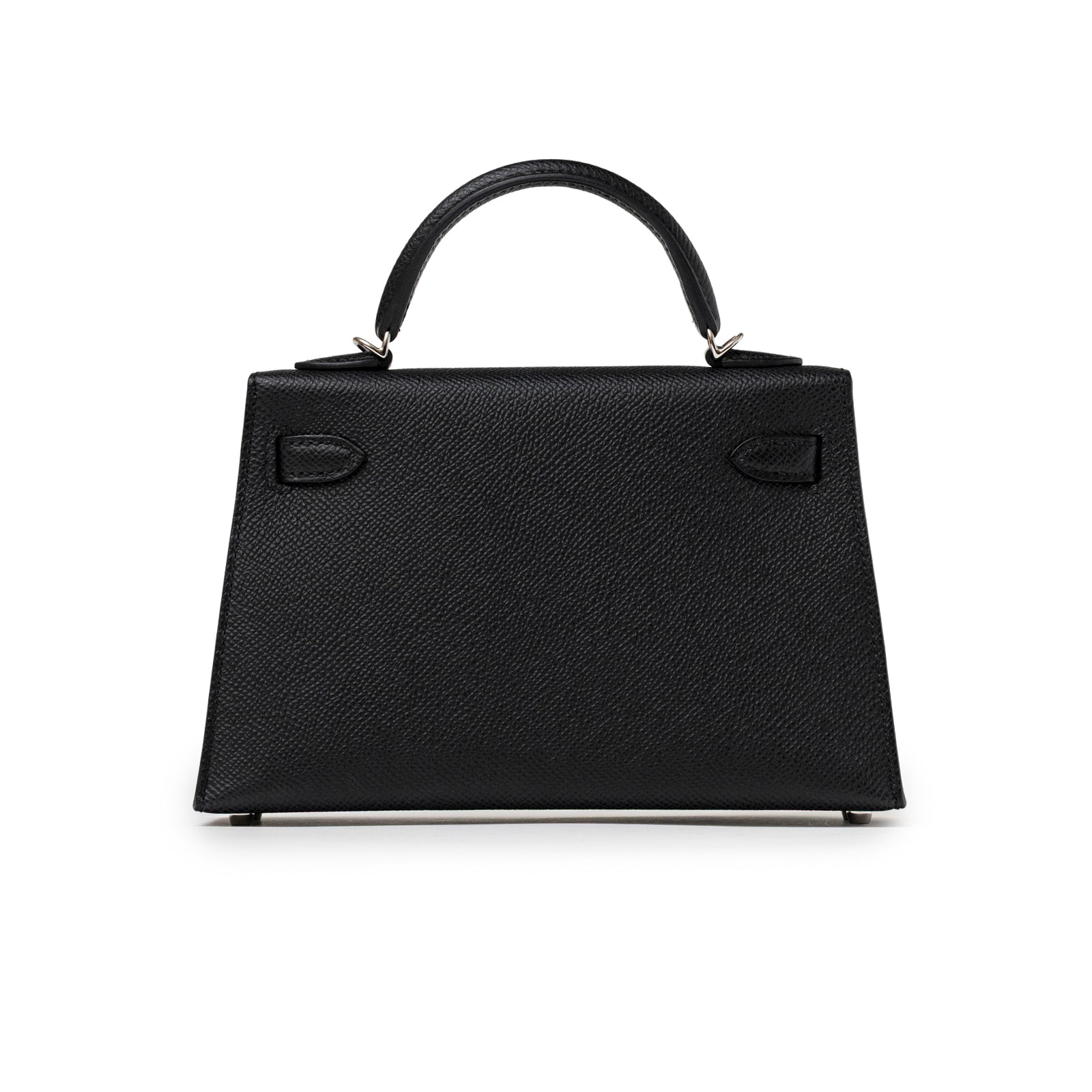 Back view of Hermès Mini Kelly II Sellier Black Epsom Palladium Hardware handbag with top handle against white background