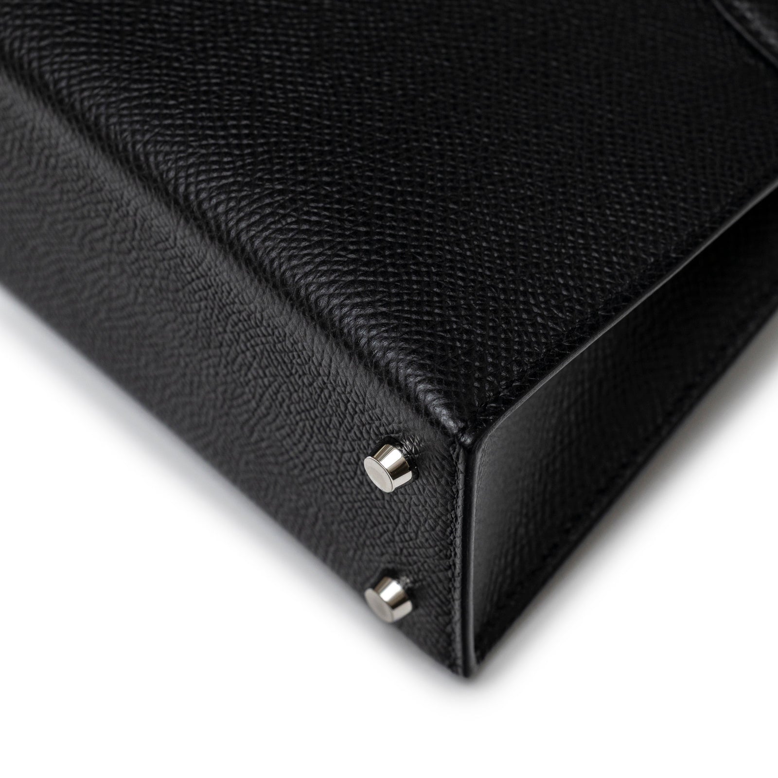 Close-up angled view of the corner and palladium feet on Hermès Mini Kelly II Sellier Black Epsom Palladium Hardware