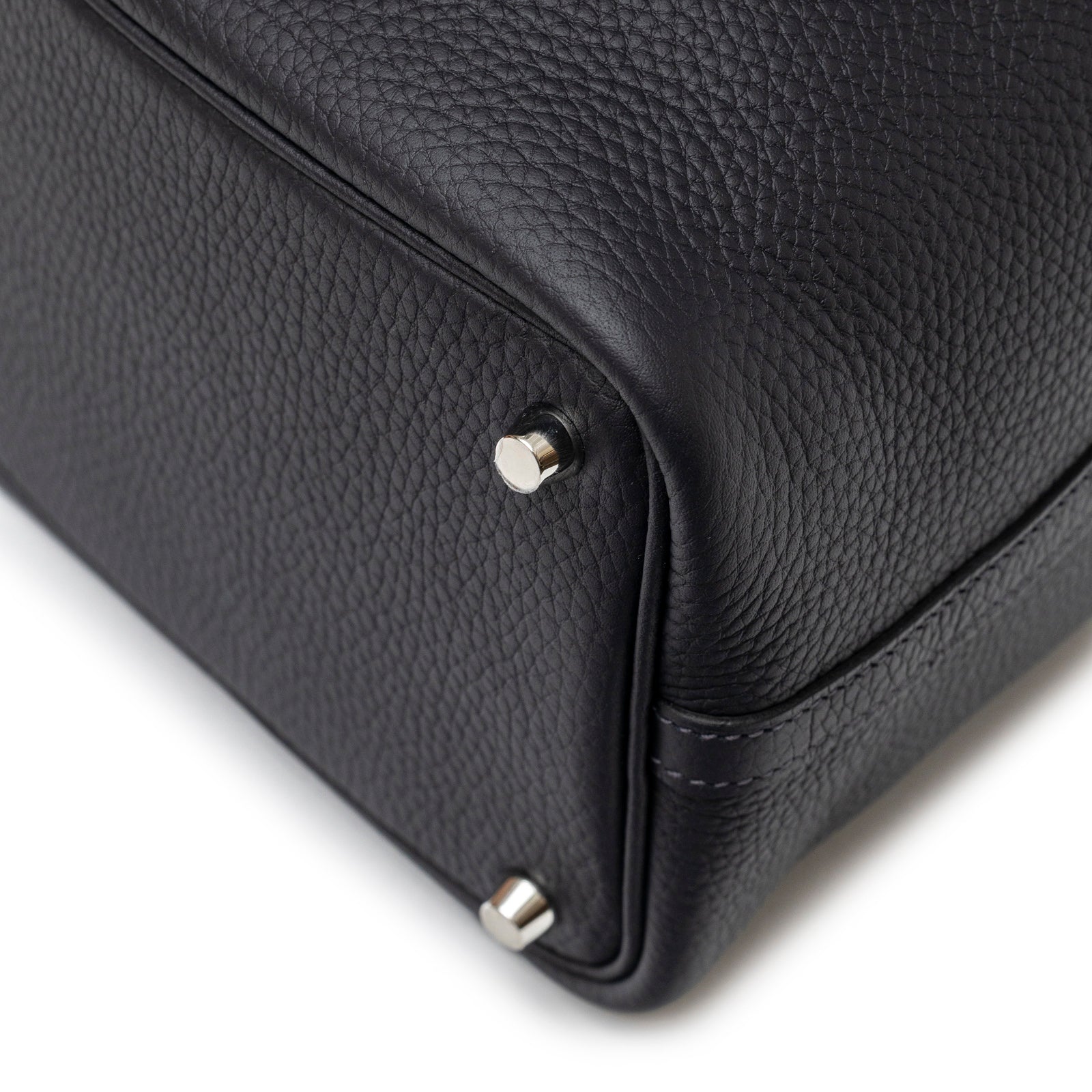 Close-up angled view of Hermès Picotin 18 Plomb Clemence Palladium Hardware bottom corner with metal studs detail