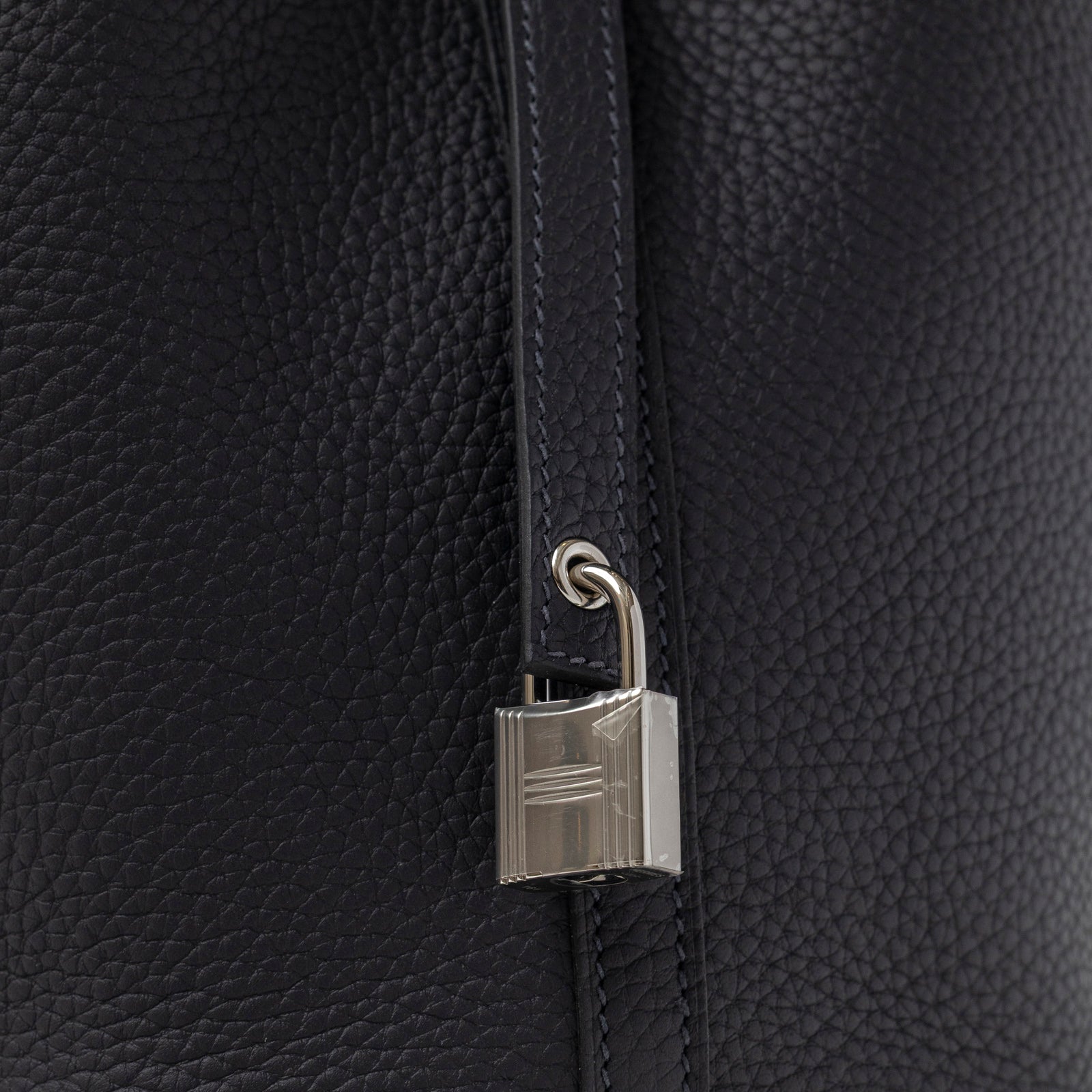 Close-up angled view of lock detail on Hermès Picotin 18 Plomb Clemence Palladium Hardware handbag
