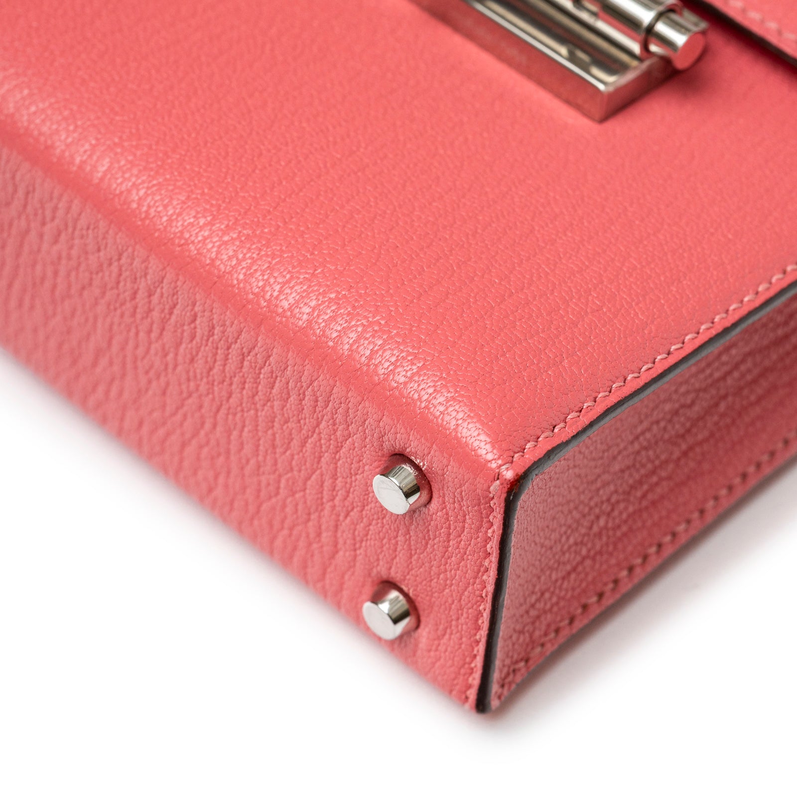 Close-up angled view of Hermès Mini Verrou Chaine Bag Rose Azalee Chevre Mysore Palladium Hardware corner studs and stitching detail