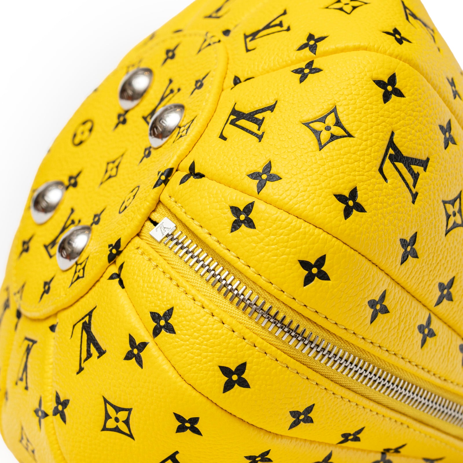 Close-up angled view of Louis Vuitton X Yayoi Kusama Limited Edition Yellow Black Leather Pumpkin Bag zipper and monogram pattern detail