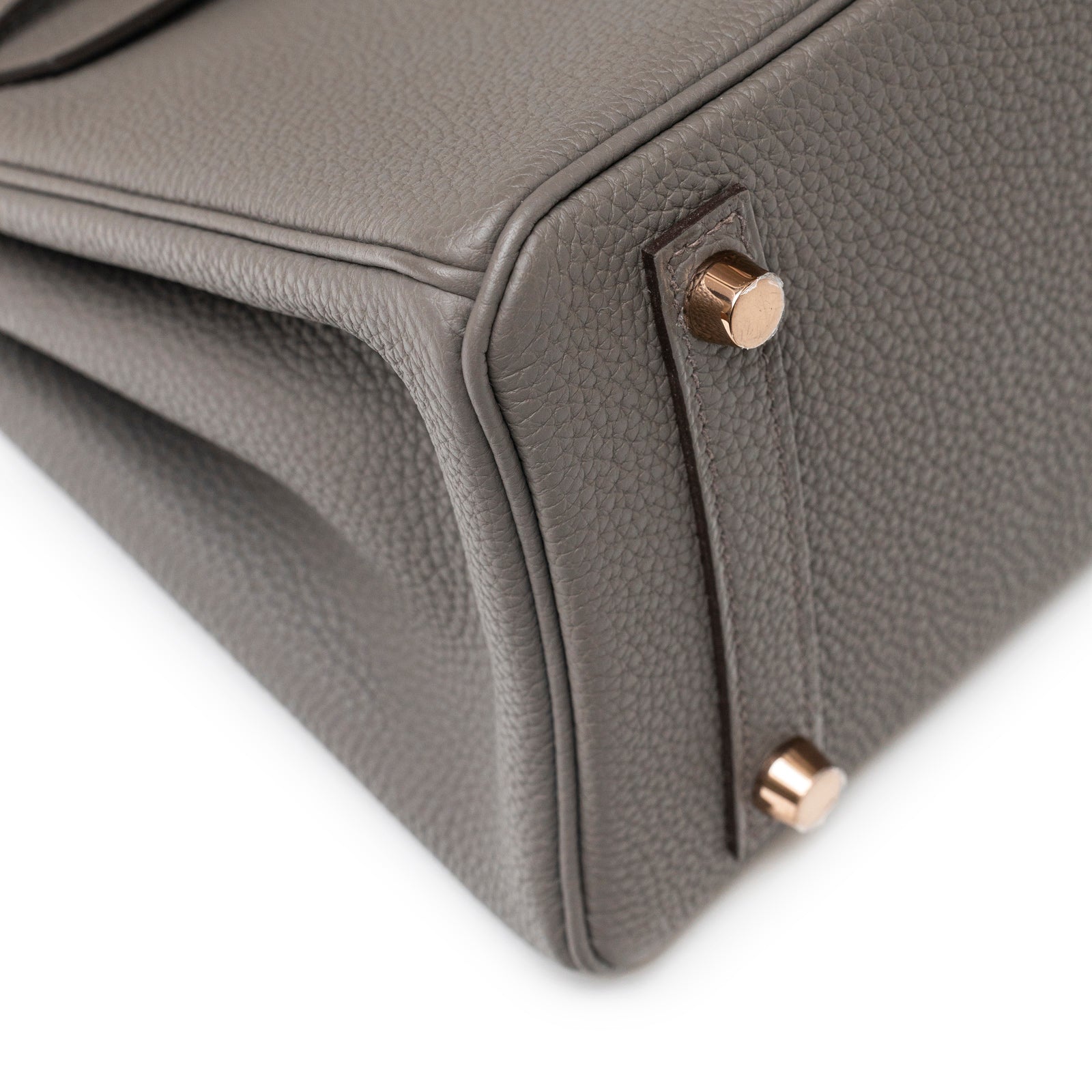 Close-up of bottom corner and rose gold feet on Hermès Birkin 25 Etain Togo Rose Gold Hardware bag