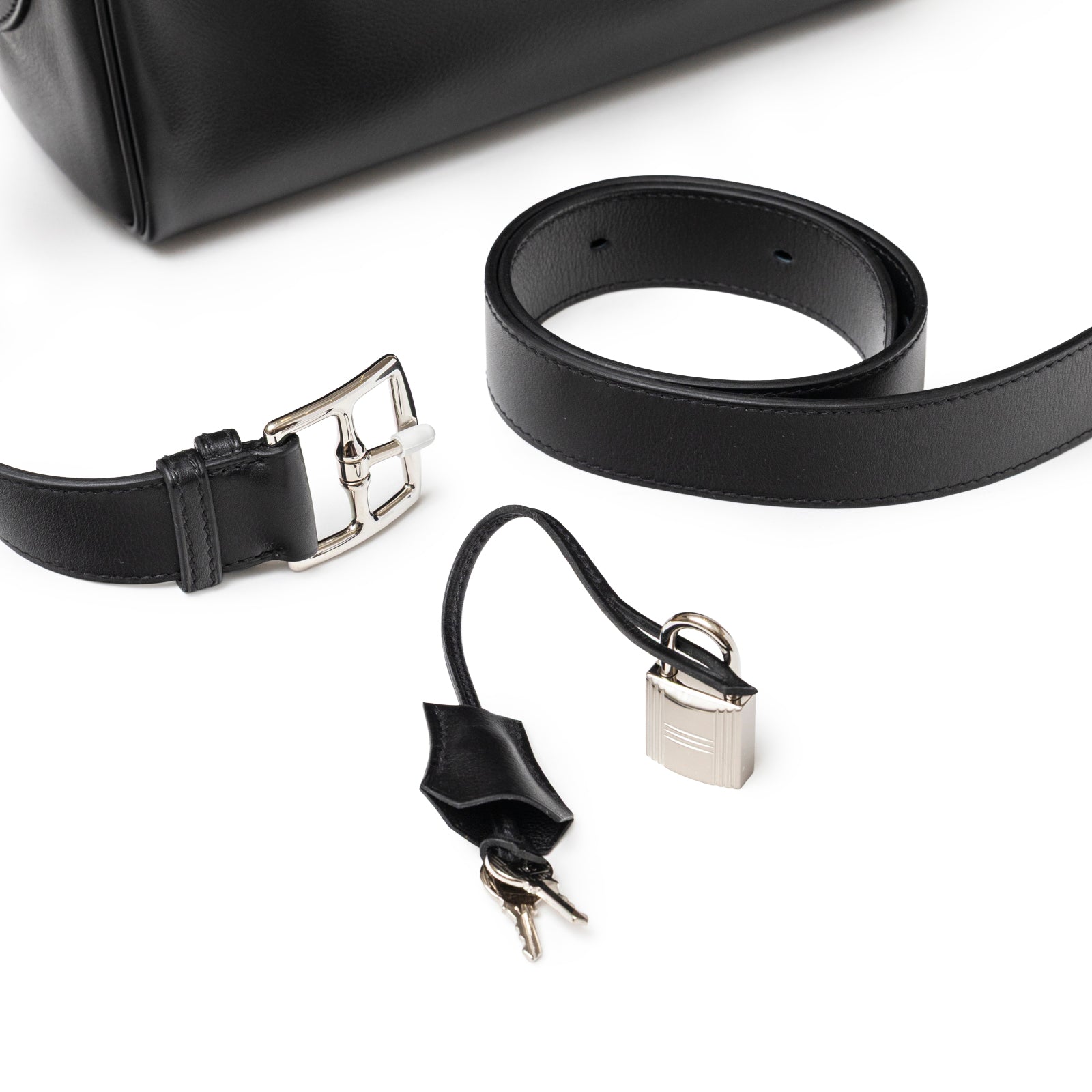 Close-up of Hermès Kelly Messenger PM Black Evergrain Palladium Hardware showing strap buckle and lock with keys details