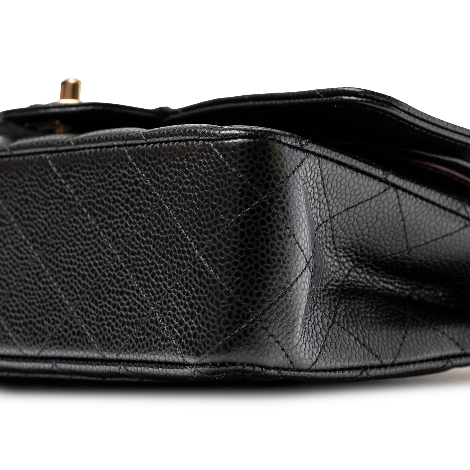 Close-up bottom view of Chanel Classic Flap Medium Caviar Black Gold Hardware showing textured leather and stitching