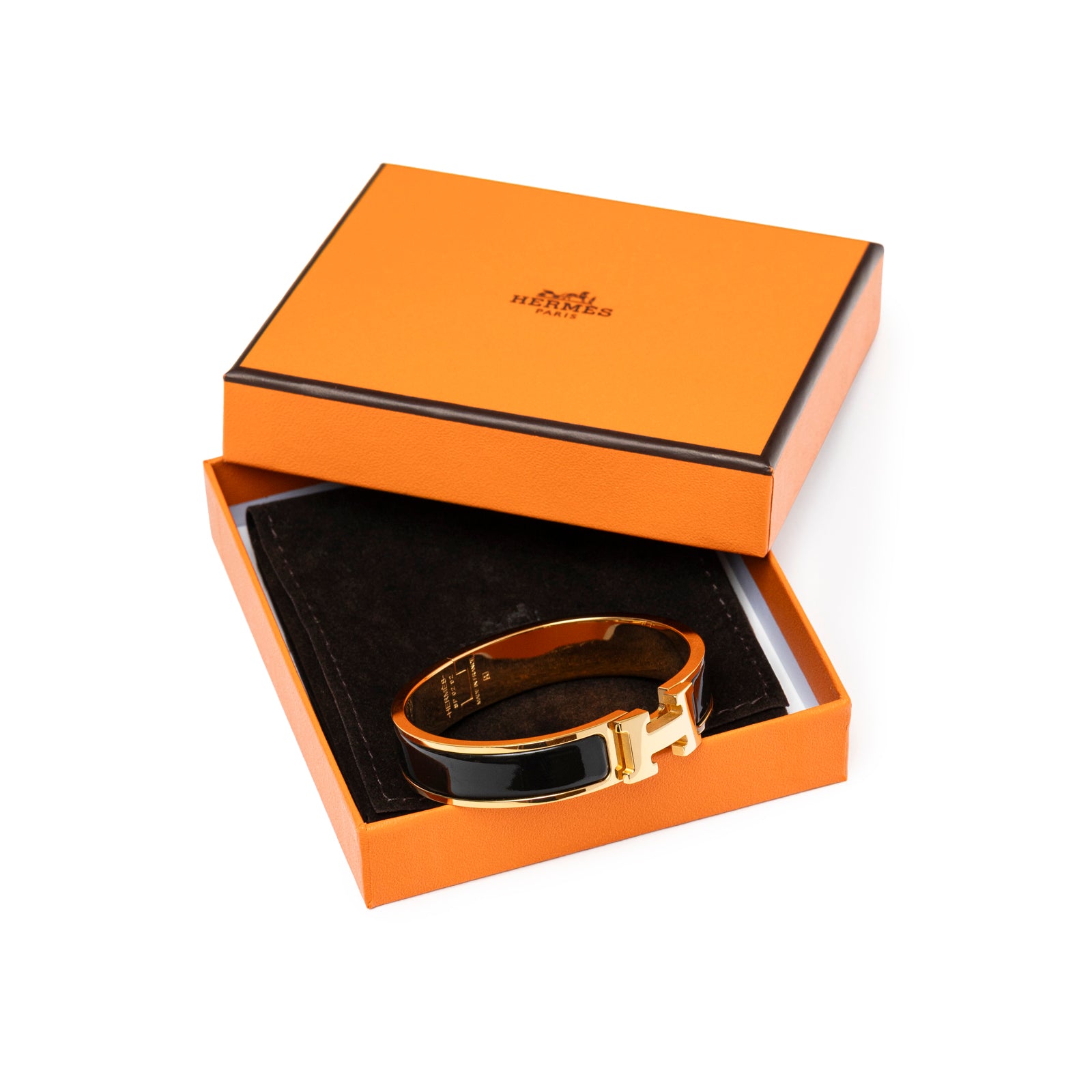 Hermès Clic H bracelet PM Black Gold Hardware angled shot in open orange box with black suede lining