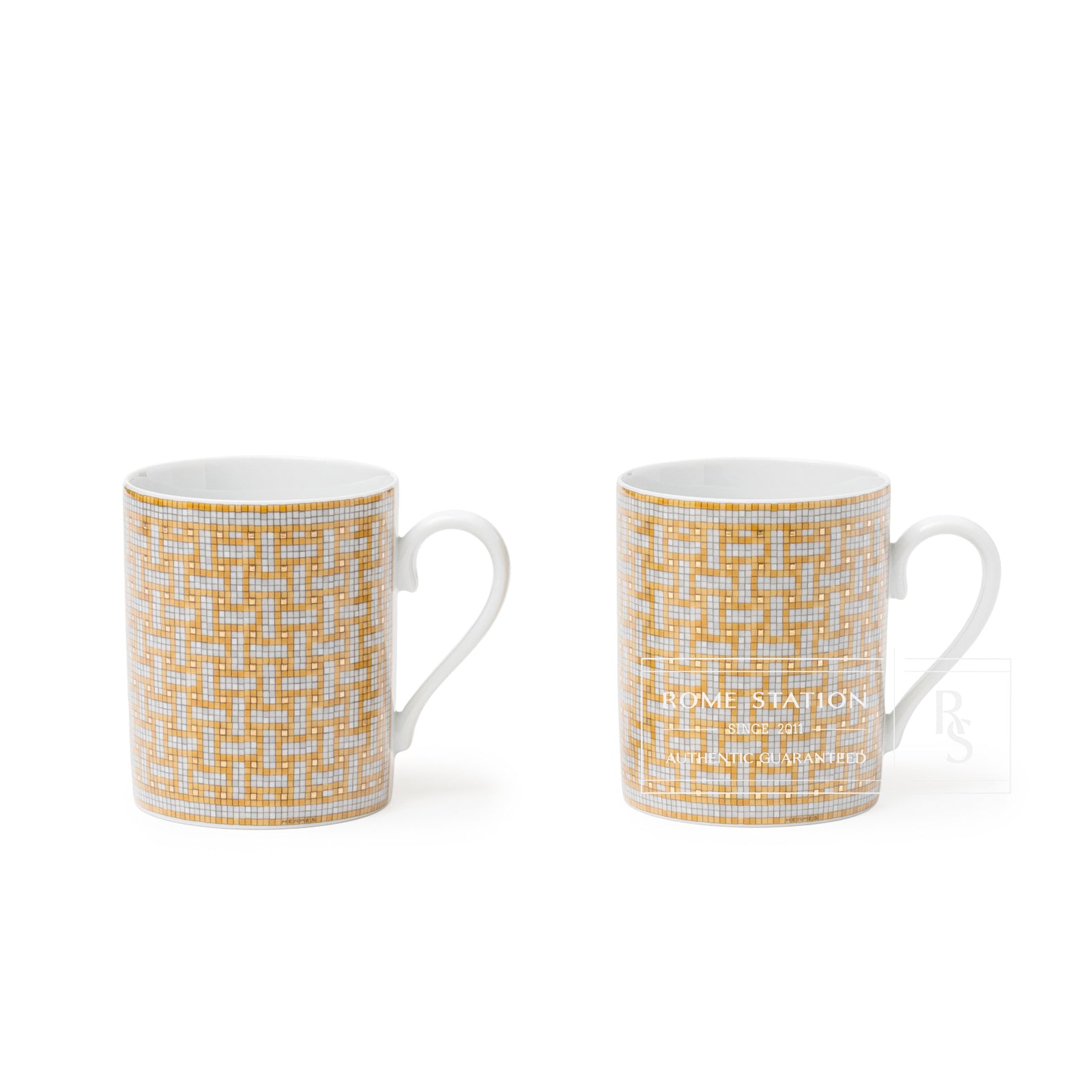 A pair of two of Hermès Mosaique au 24 Gold Mug showcasing its intricate gold mosaic pattern and white handle