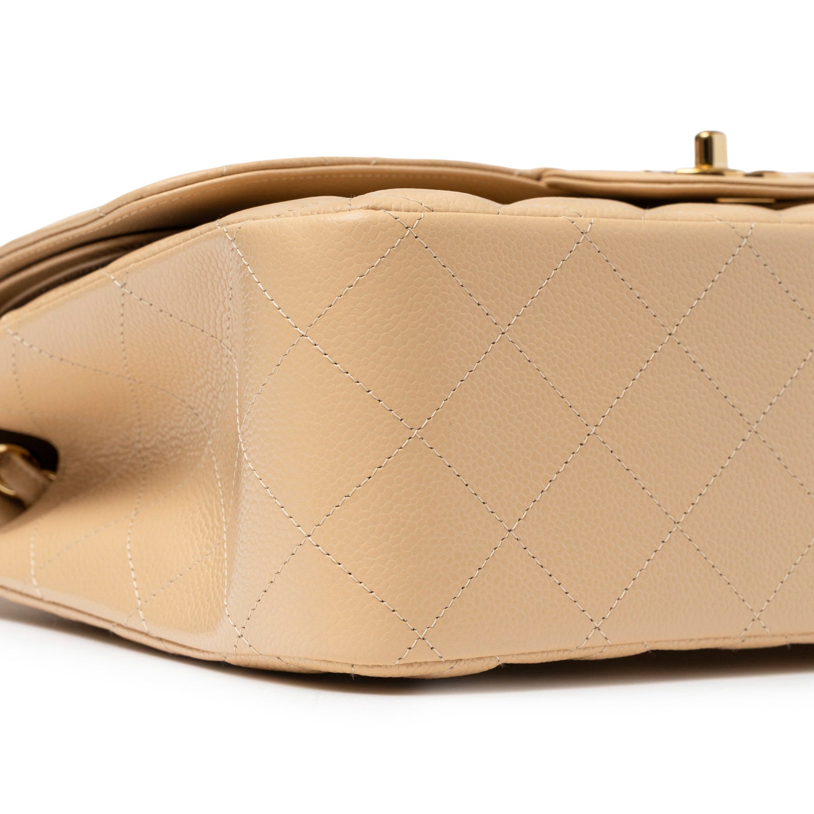 Close-up side view of Chanel Classic Flap Jumbo Caviar Beige Gold Hardware showing quilted leather detail