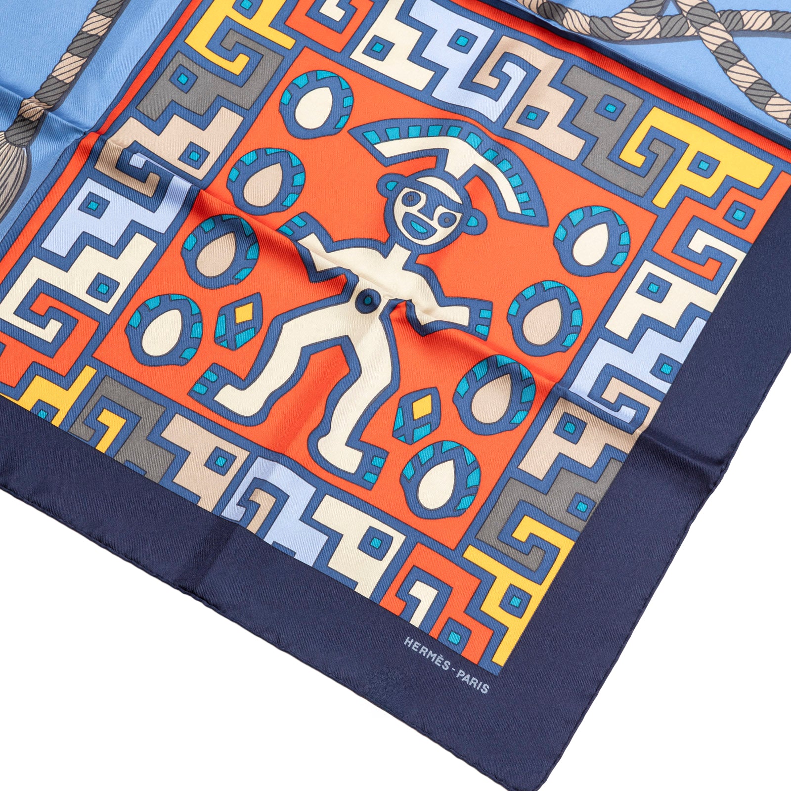 Close-up angled shot of Hermès Carre 90 Huaca Piru 2 Silk Scarf Blue Marine Orange Rouge showing vibrant design details