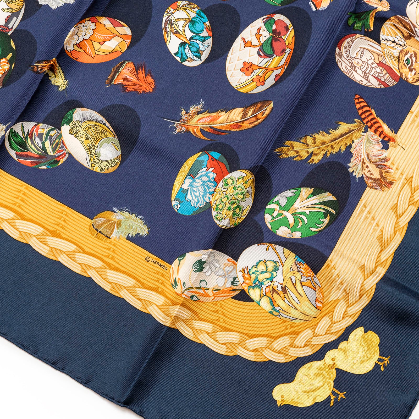 Close-up of Hermès Carre 90 Couvee d'Silk Scarf Blue Multi showing detailed egg and feather motifs with yellow border trim