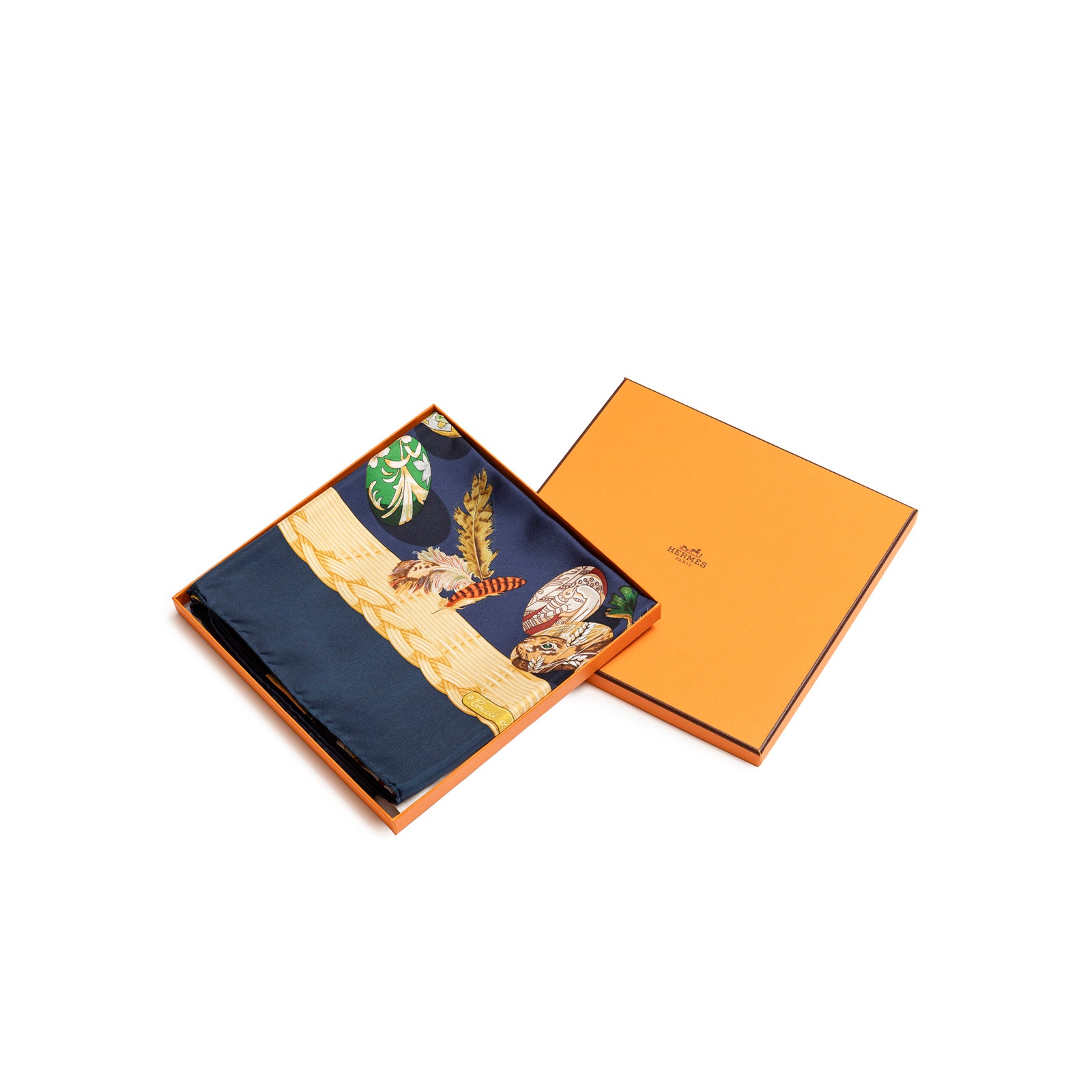 Angled top view of folded Hermès Carre 90 Couvee d'Silk Scarf Blue Multi inside signature orange box showing detailed pattern edges