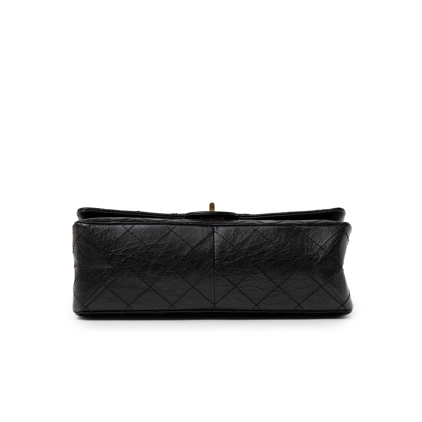 Bottom close-up of Chanel 2.55 Reissue 226 Flap Black Aged Calfskin Brushed Gold Hardware handbag showing textured leather and stitching