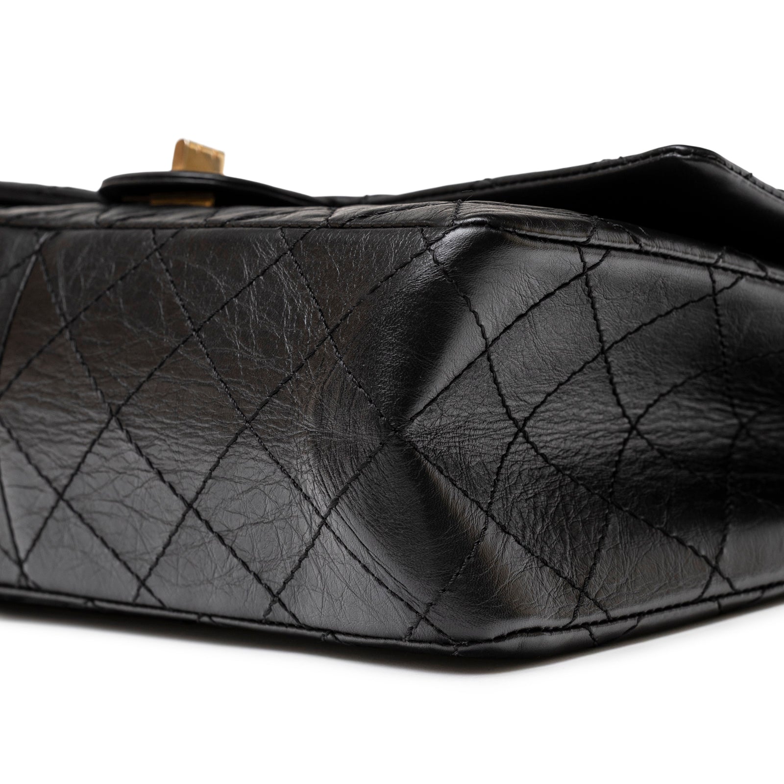 Close-up of the bottom corner showing black aged calfskin and quilted pattern on Chanel 2.55 Reissue 226 Flap Black Aged Calfskin Brushed Gold Hardware