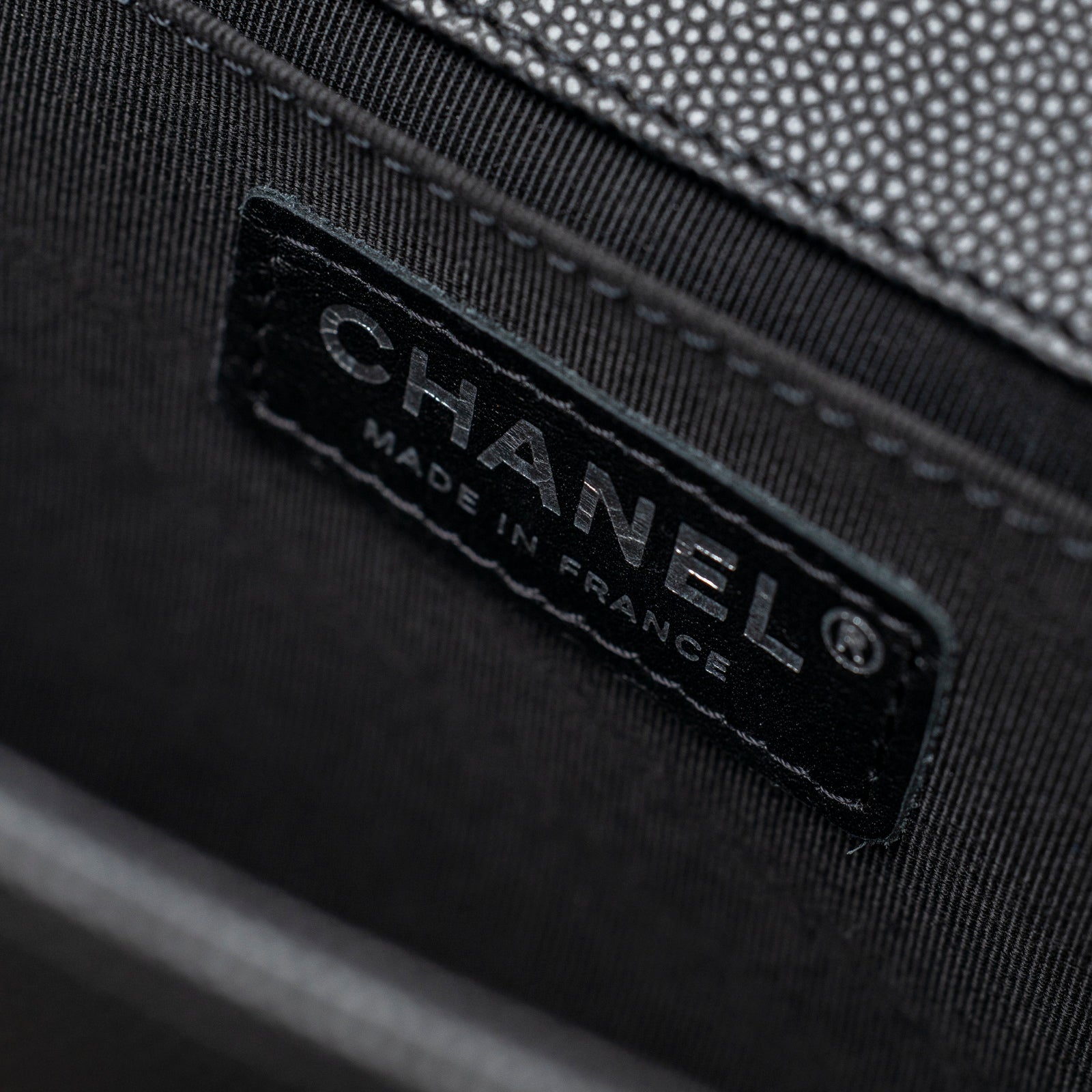 Close-up of interior label on Chanel Boy Bag Medium Black Caviar Aged Ruthenium Hardware showing Made in France text