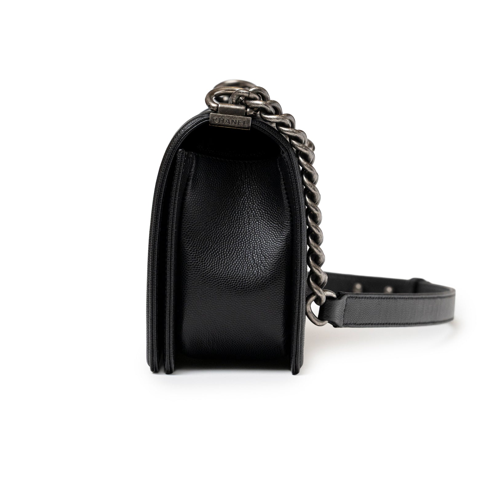 Side view of Chanel Boy Bag Medium Black Caviar Aged Ruthenium Hardware with chain strap and pebbled leather texture
