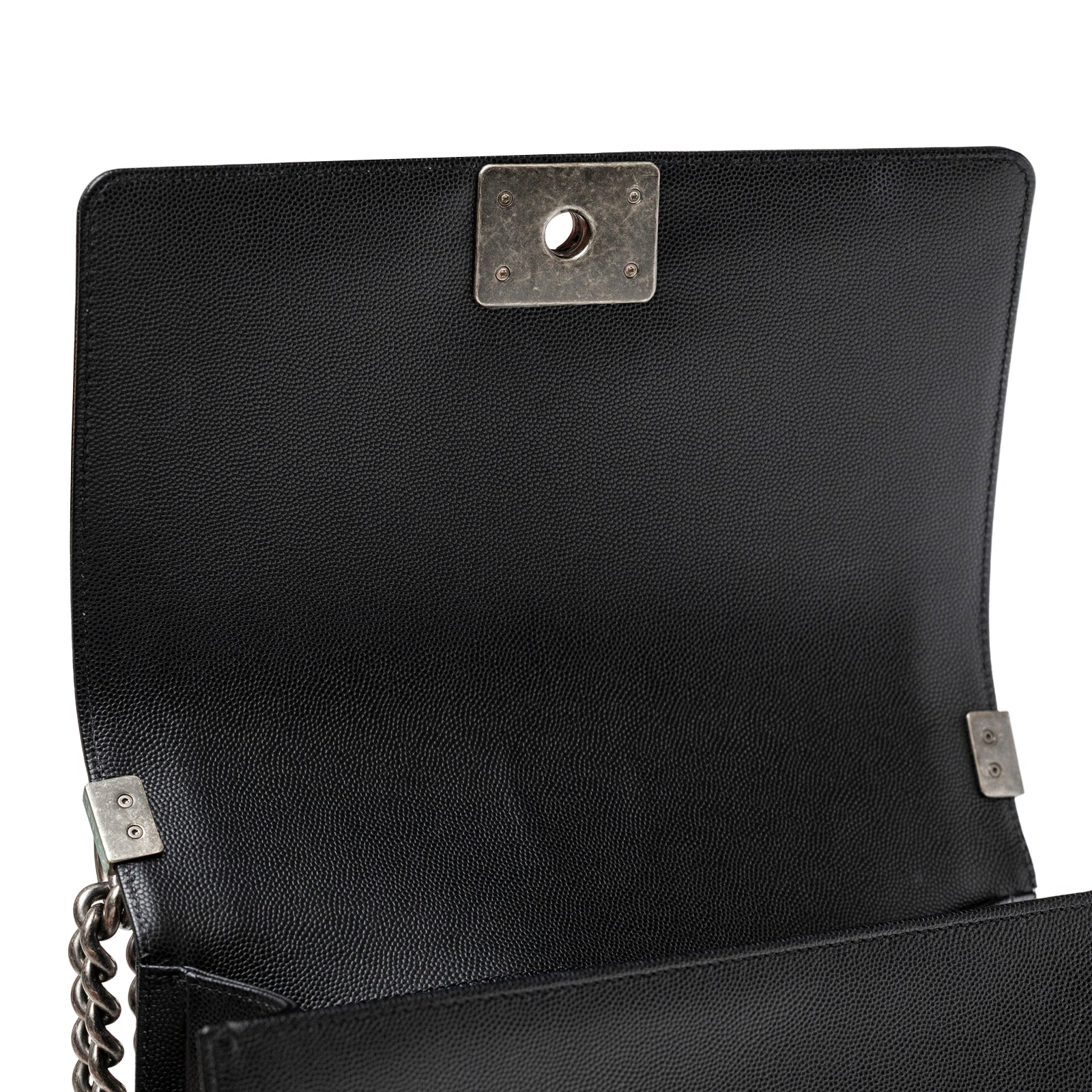 Close-up interior view of Chanel Boy Bag Medium Black Caviar Aged Ruthenium Hardware showing flap and clasp details
