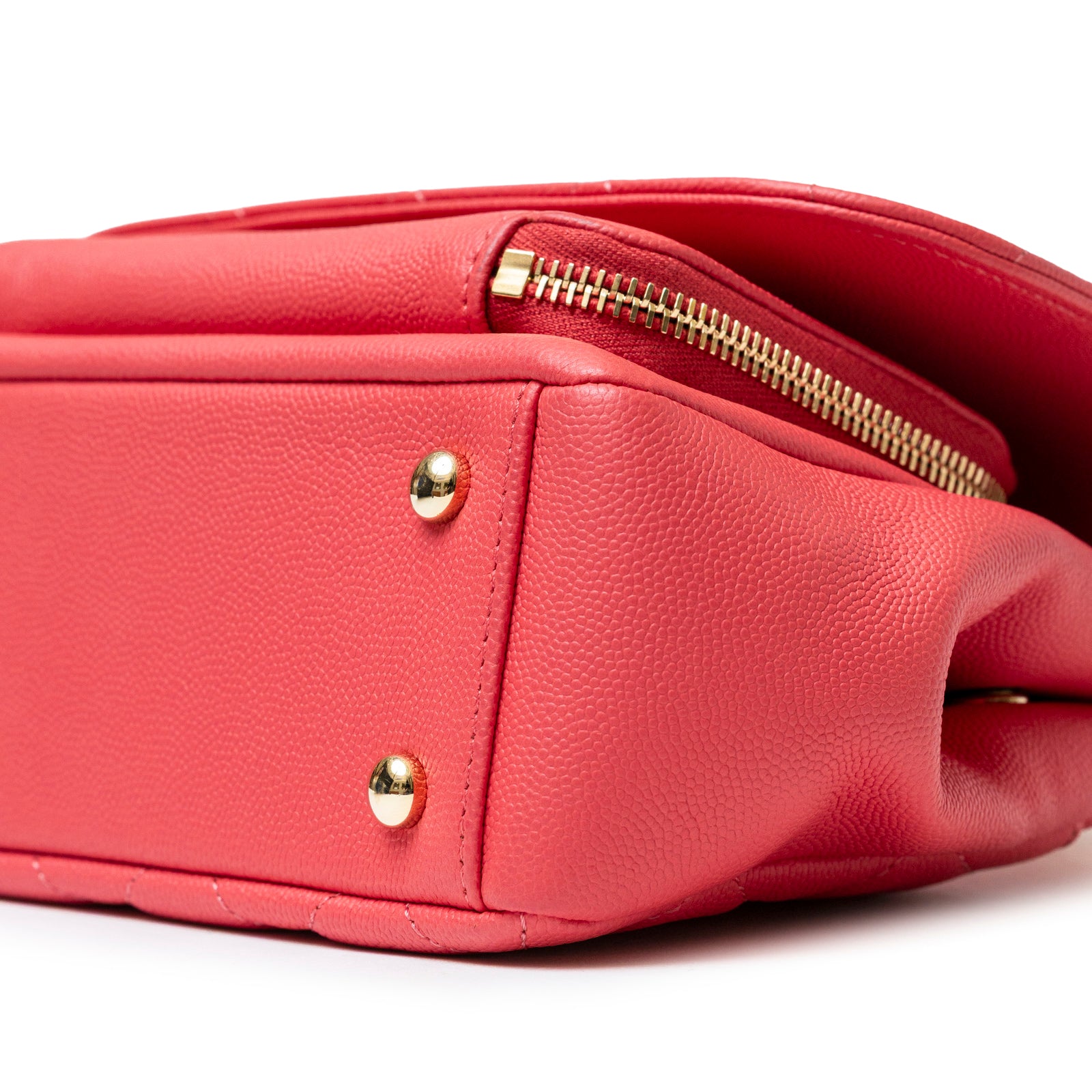 Close-up of the bottom corner of Chanel Business Affinity Small Flap Bag Pink Caviar Light Gold Hardware showing texture and zipper detail