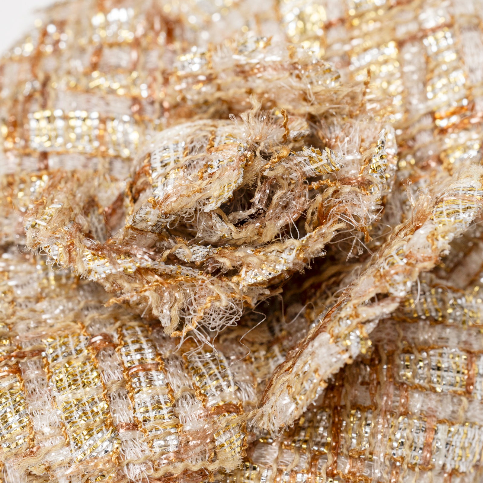Close-up of textured fabric petals with gold threads on Chanel Camellia Gold Beige Tweed Brooch front view