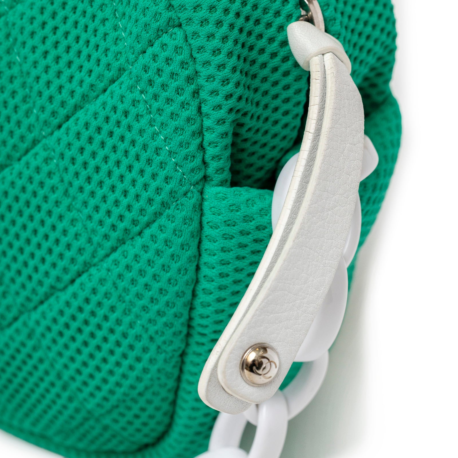 Close-up angled view of green mesh fabric and white chain detail on Chanel CC Sport Jersey Bag Green White Chain