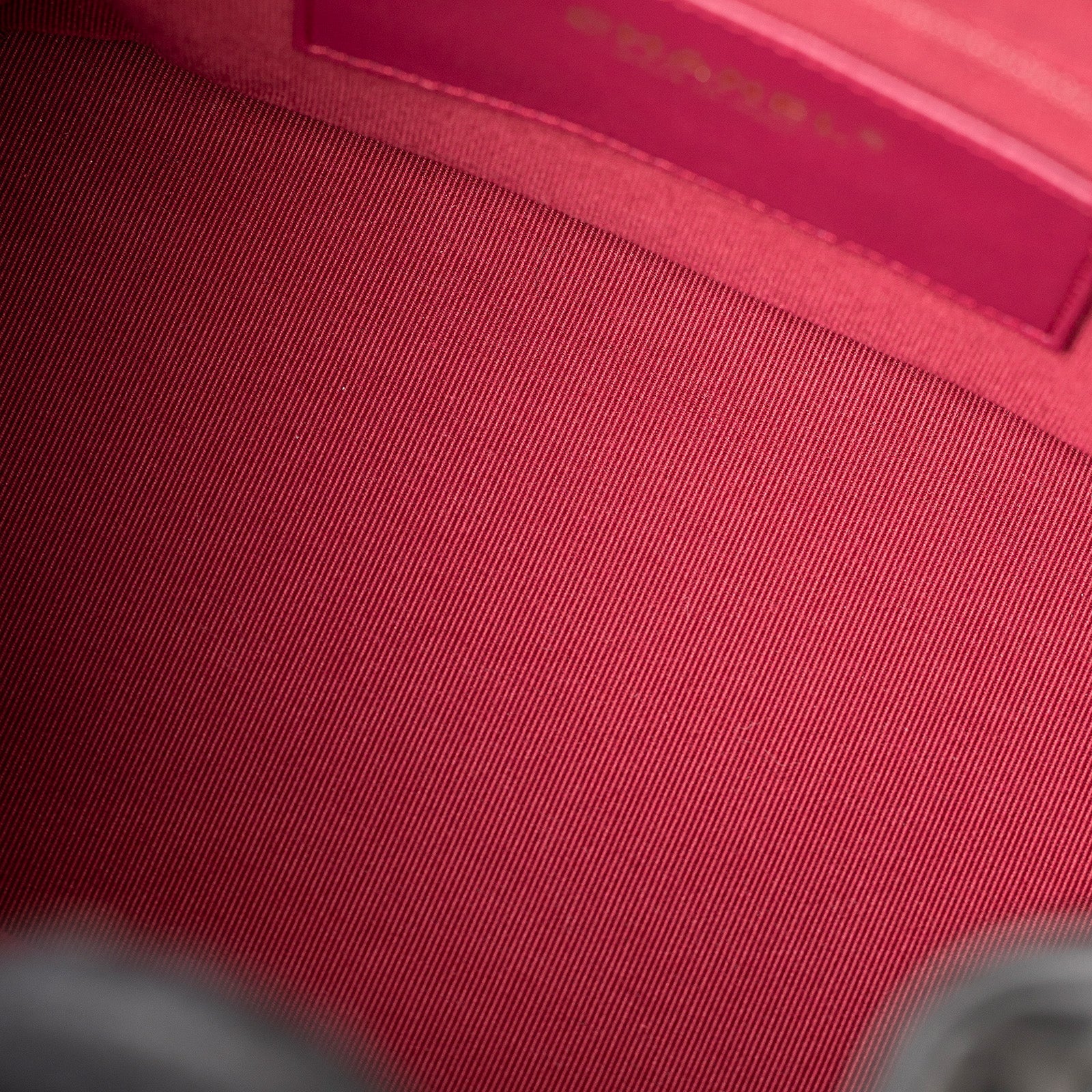 Close-up interior view of red lining inside Chanel Coco Mellow Backpack Calf Black Permabrass Hardware 23B