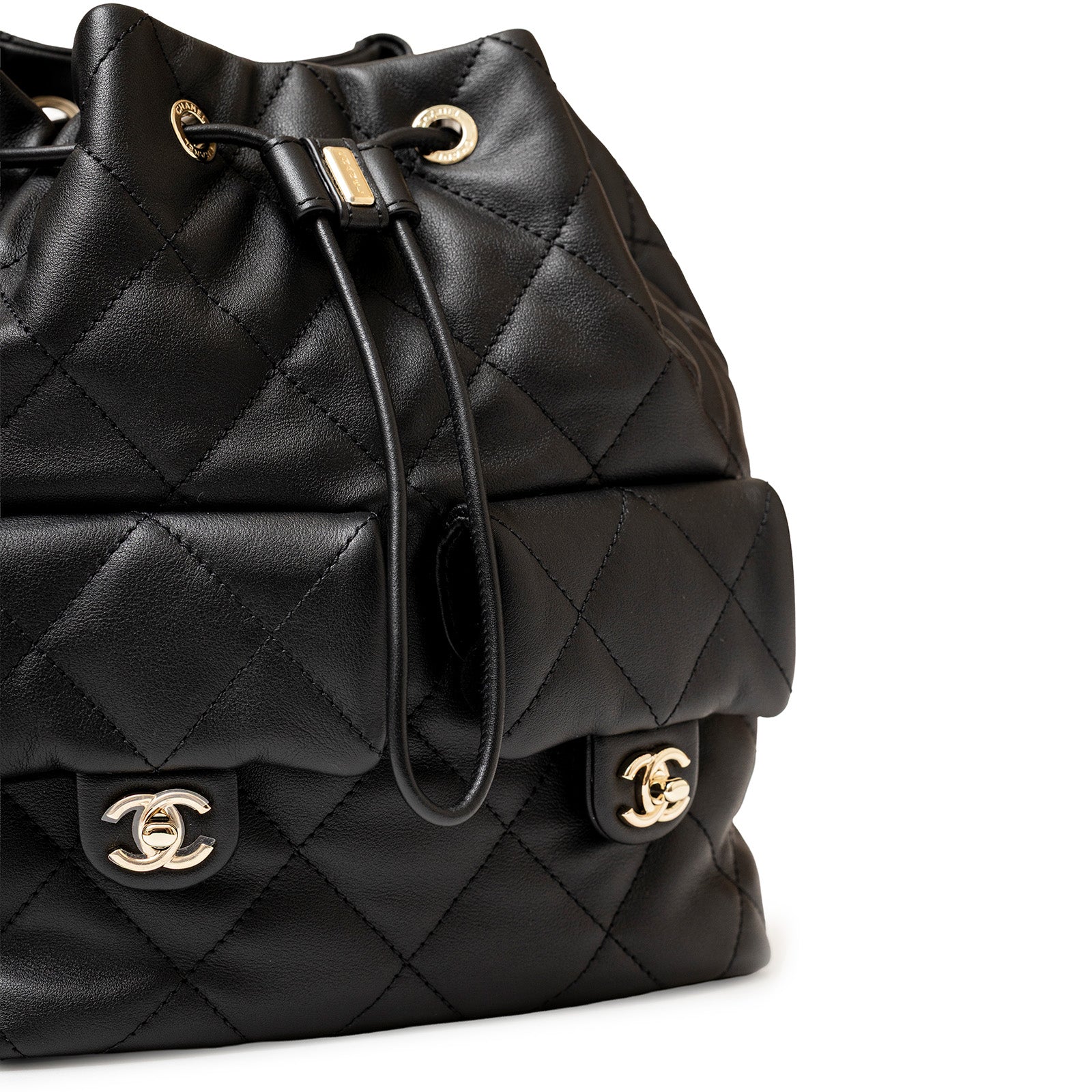 Close-up angled view of Chanel Coco Mellow Backpack Calf Black Permabrass Hardware 23B showing quilted leather and clasp detail