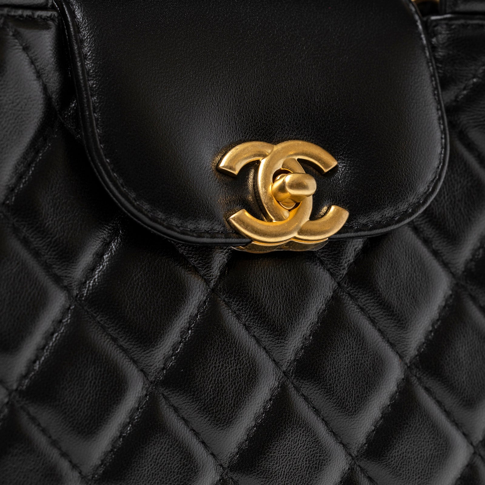 Close-up of Chanel Kelly Shopper Small Black Shiny Aged Calfskin Brushed Gold Hardware with signature interlocking clasp