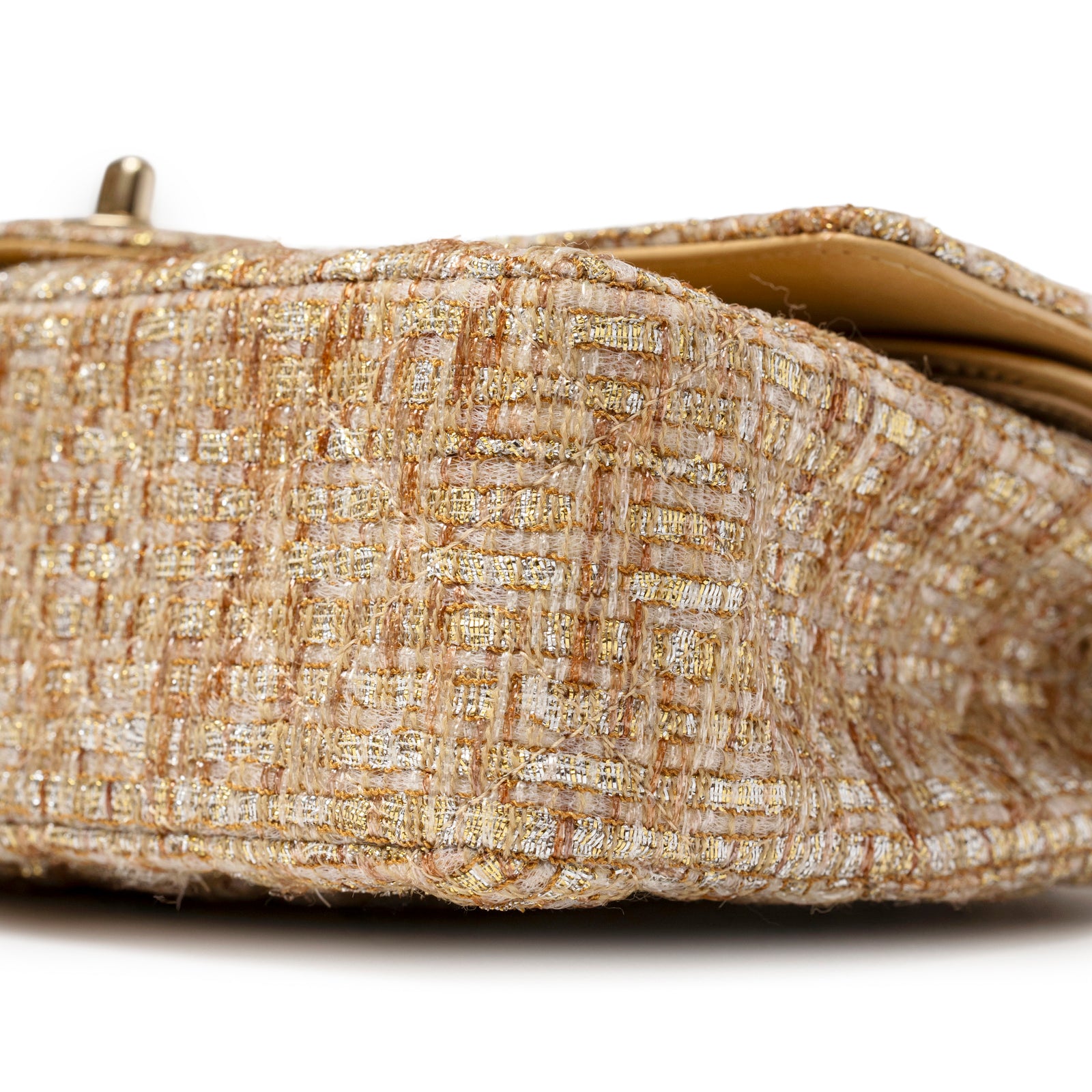 Close-up of bottom corner on Chanel Classic Double Flap Medium Gold Beige Tweed Gold Hardware showing textured fabric and stitching detail