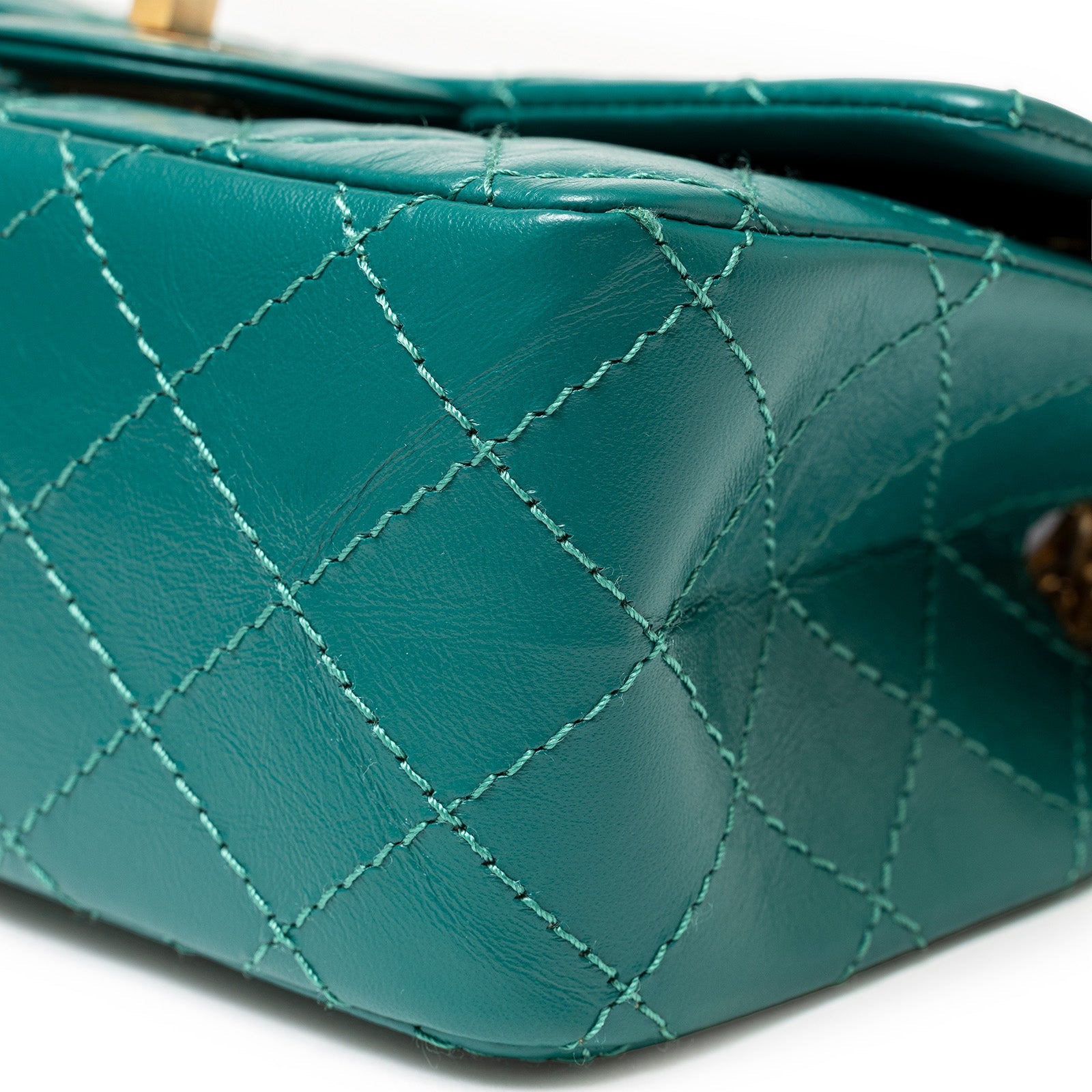 Close-up of green calf leather corner showing stitching on Chanel Mini Reissue 2.55 Flap Bag Green Calf Brushed Gold Hardware