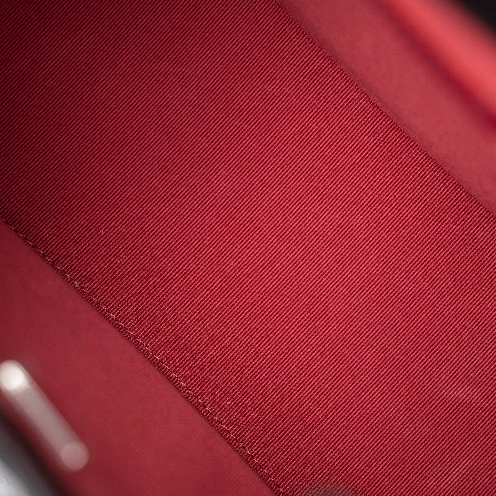 Close-up of the red interior fabric lining inside the Chanel Small Gabrielle Backpack Black Aged Calfskin Mixed Metal Hardware.