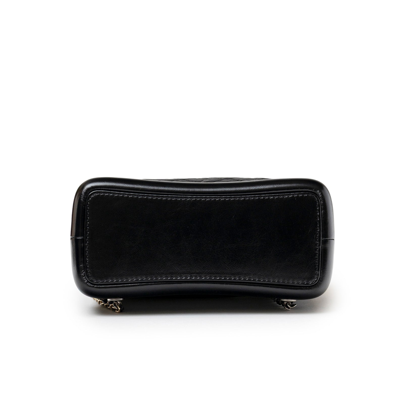 Bottom view of Chanel Small Gabrielle Backpack Black Aged Calfskin Mixed Metal Hardware showing smooth leather base