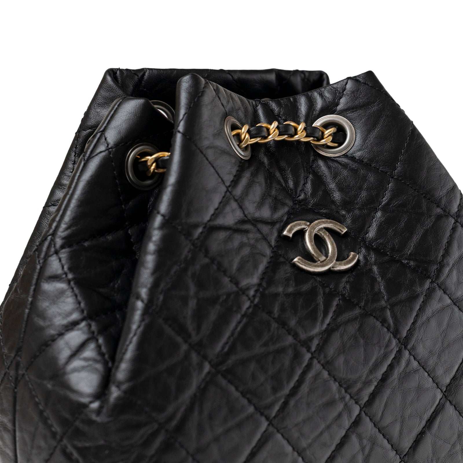 Close-up of Chanel Small Gabrielle Backpack Black Aged Calfskin Mixed Metal Hardware showing quilted texture and metal chain details