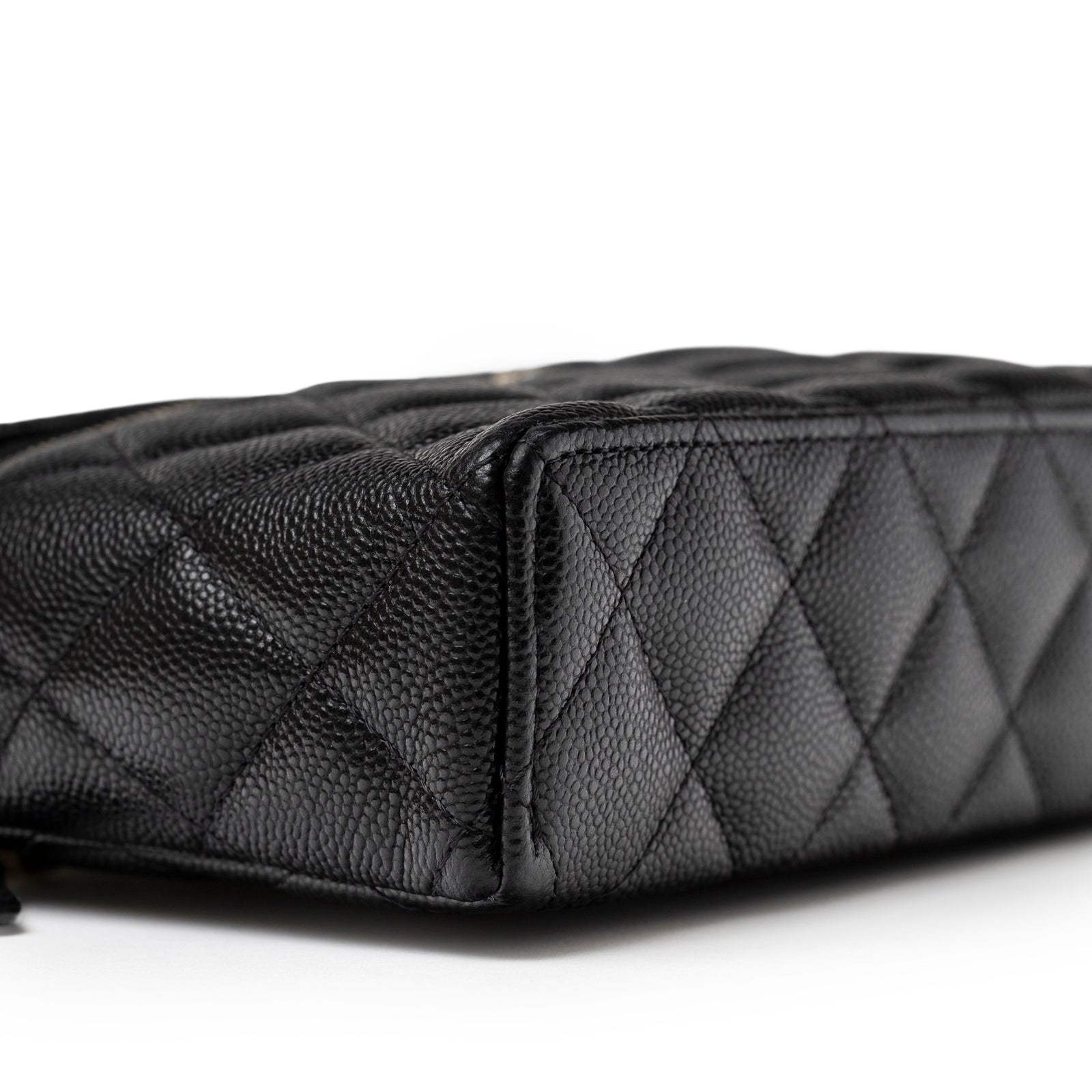 Close-up of corner showing textured black caviar leather on Chanel Top Handle Vanity with Chain Black Caviar Light Gold Hardware