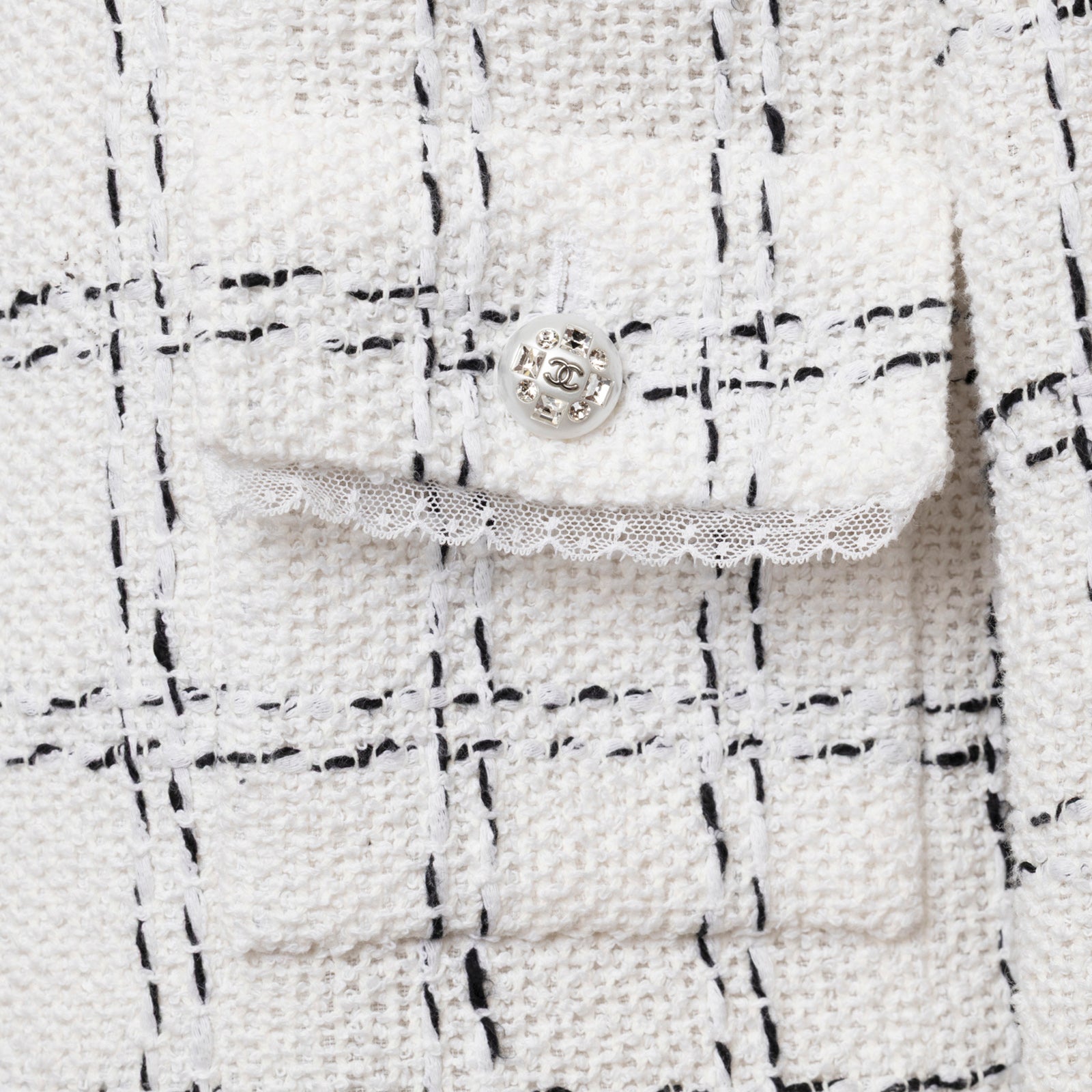 Close-up detail of Chanel Tweed Jacket 23S Pearl and Crystal Button White/Black showing textured fabric and button design