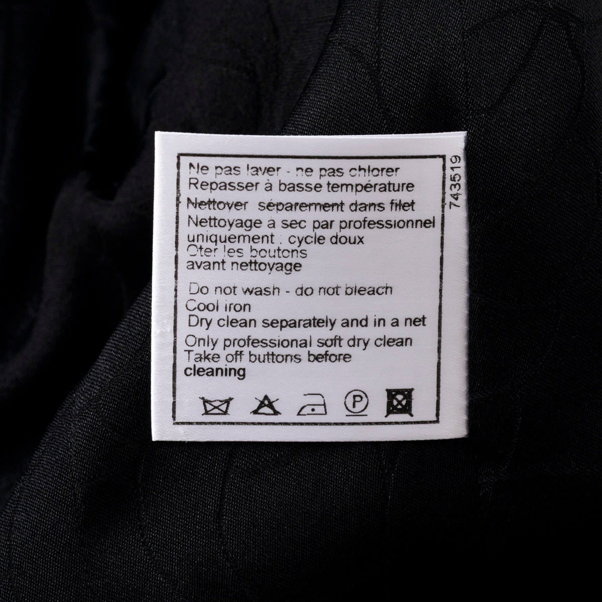 Close-up of care label on Chanel Vintage Tweed Jacket with Butterfly Bow Tie Black & White showing washing instructions.