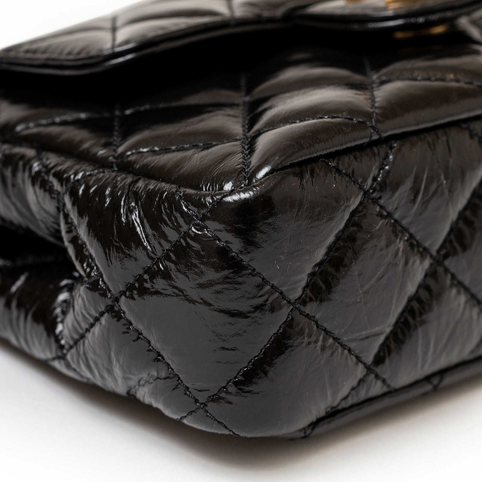 Close-up of the corner stitching on the Chanel Wavy CC Hobo Small Shiny Quilted Calf Gold Hardware bag showing glossy quilted leather
