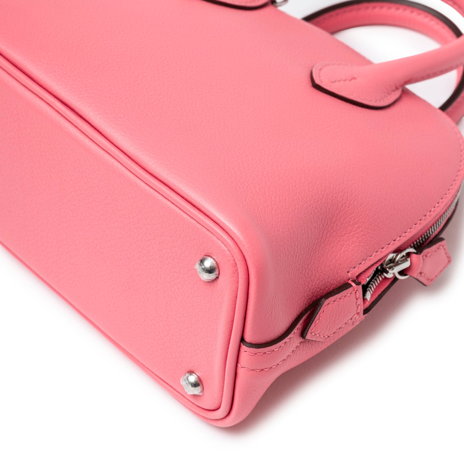 Close-up of bottom corner hardware and textured leather on Hermès 1923 Bolide Mini Rose Azalee Swift Palladium Hardware handbag