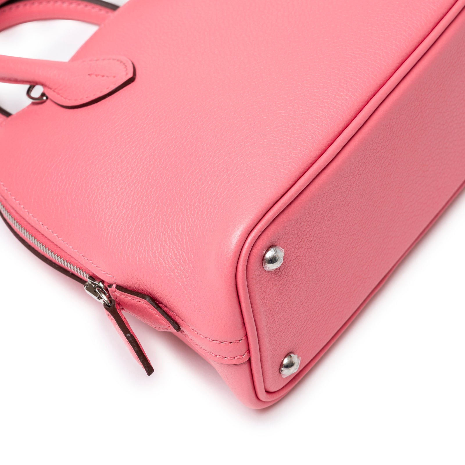 Close-up of bottom corner with palladium feet and pink Swift leather on Hermès 1923 Bolide Mini Rose Azalee Swift Palladium Hardware