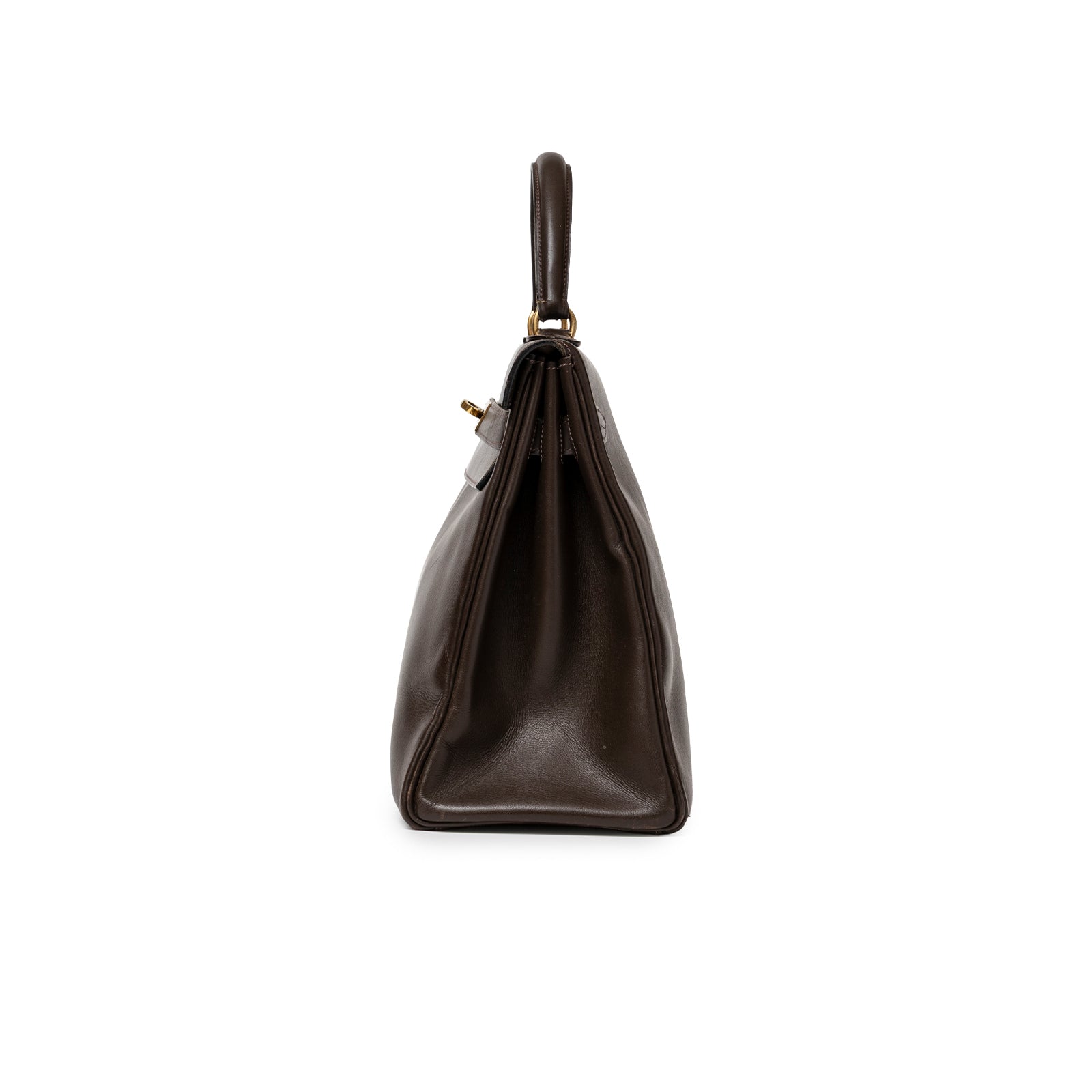 Side profile of Hermès 1974 Vintage Kelly 32 Marron Foncé Box Gold Hardware showing smooth leather and handle details