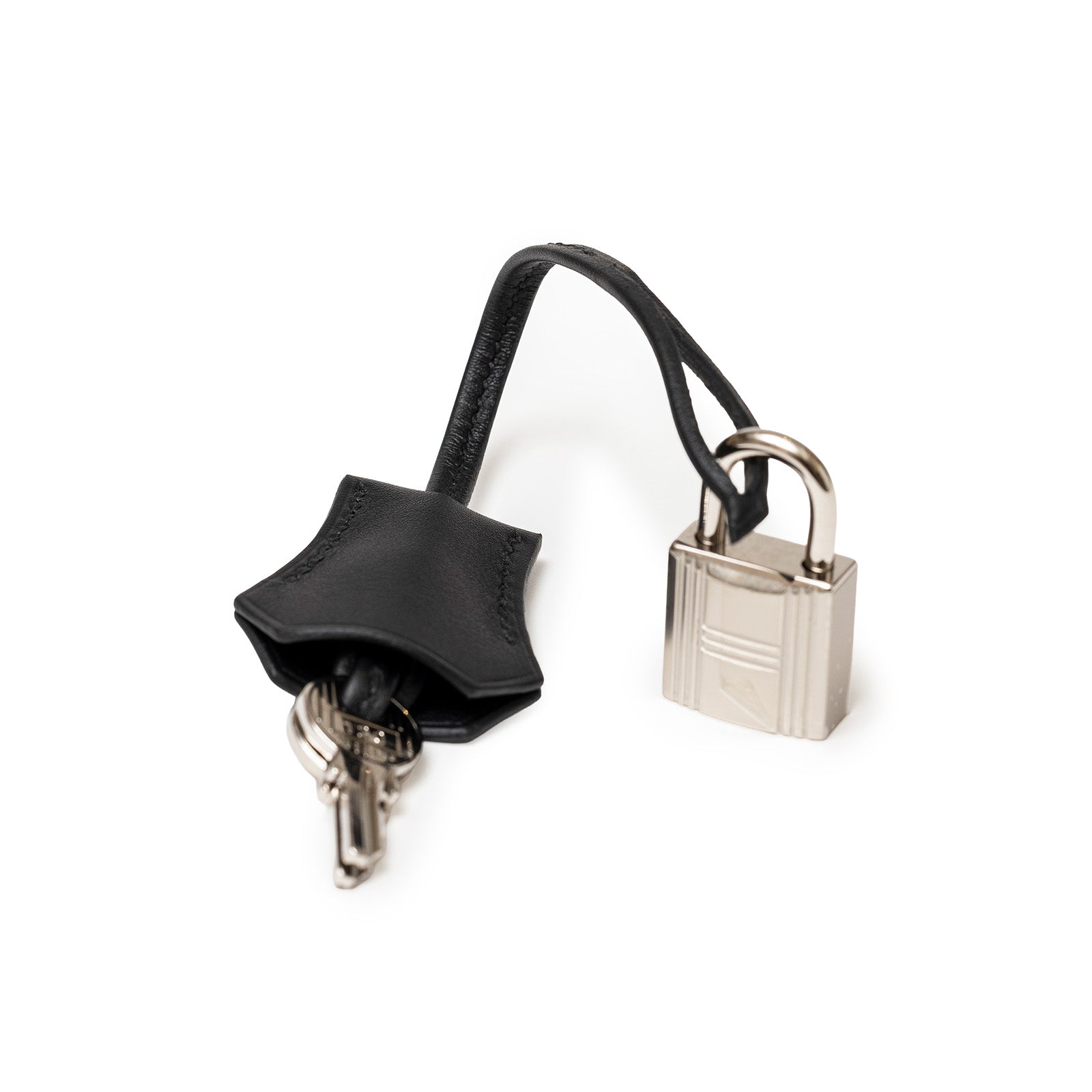 Close-up of lock and keys for Hermès Birkin 25 Black Swift/Ecru Toile H Canvas Palladium Hardware by Hermès