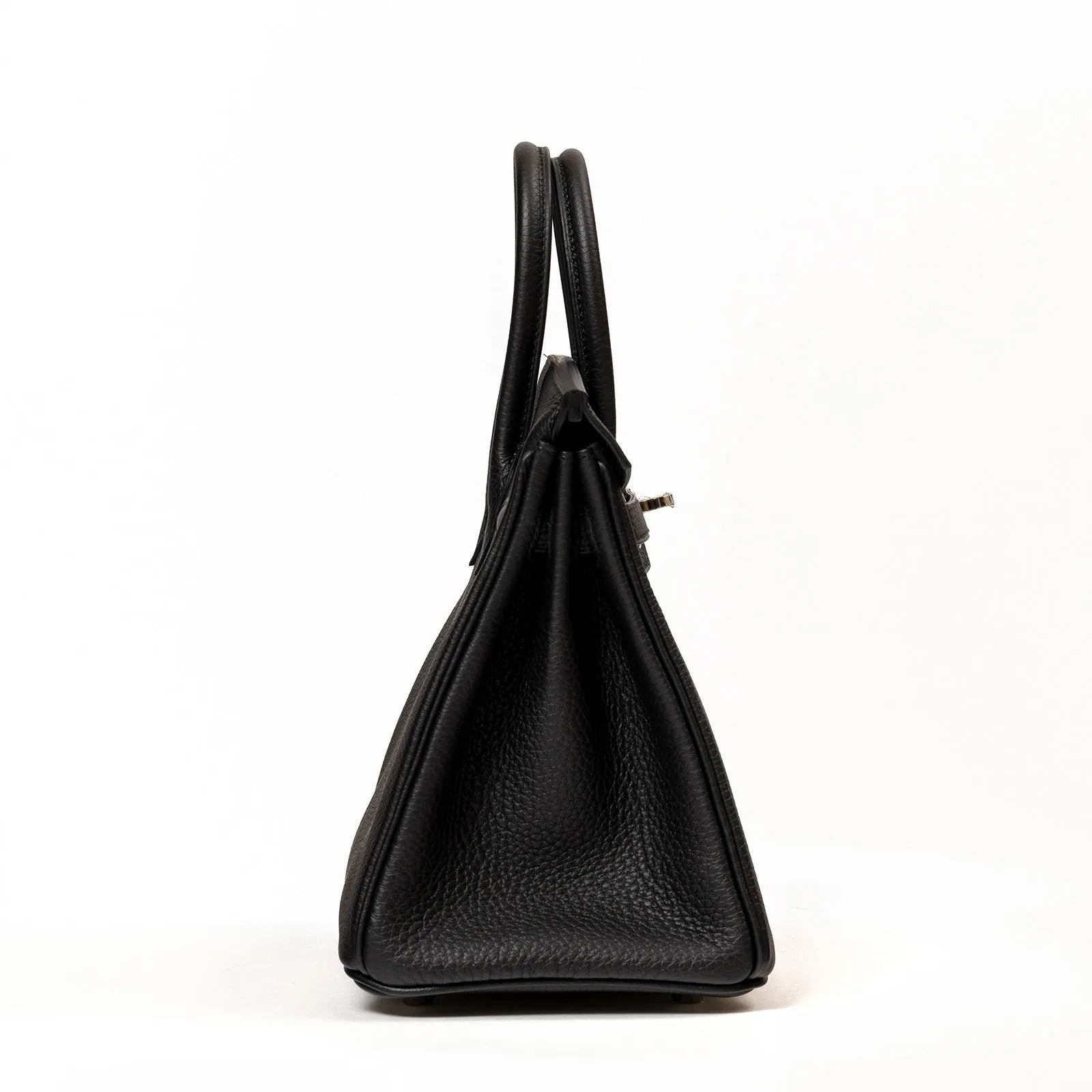 Side profile of Hermès Birkin 25 in black Togo leather showing smooth textures and palladium hardware glimpse
