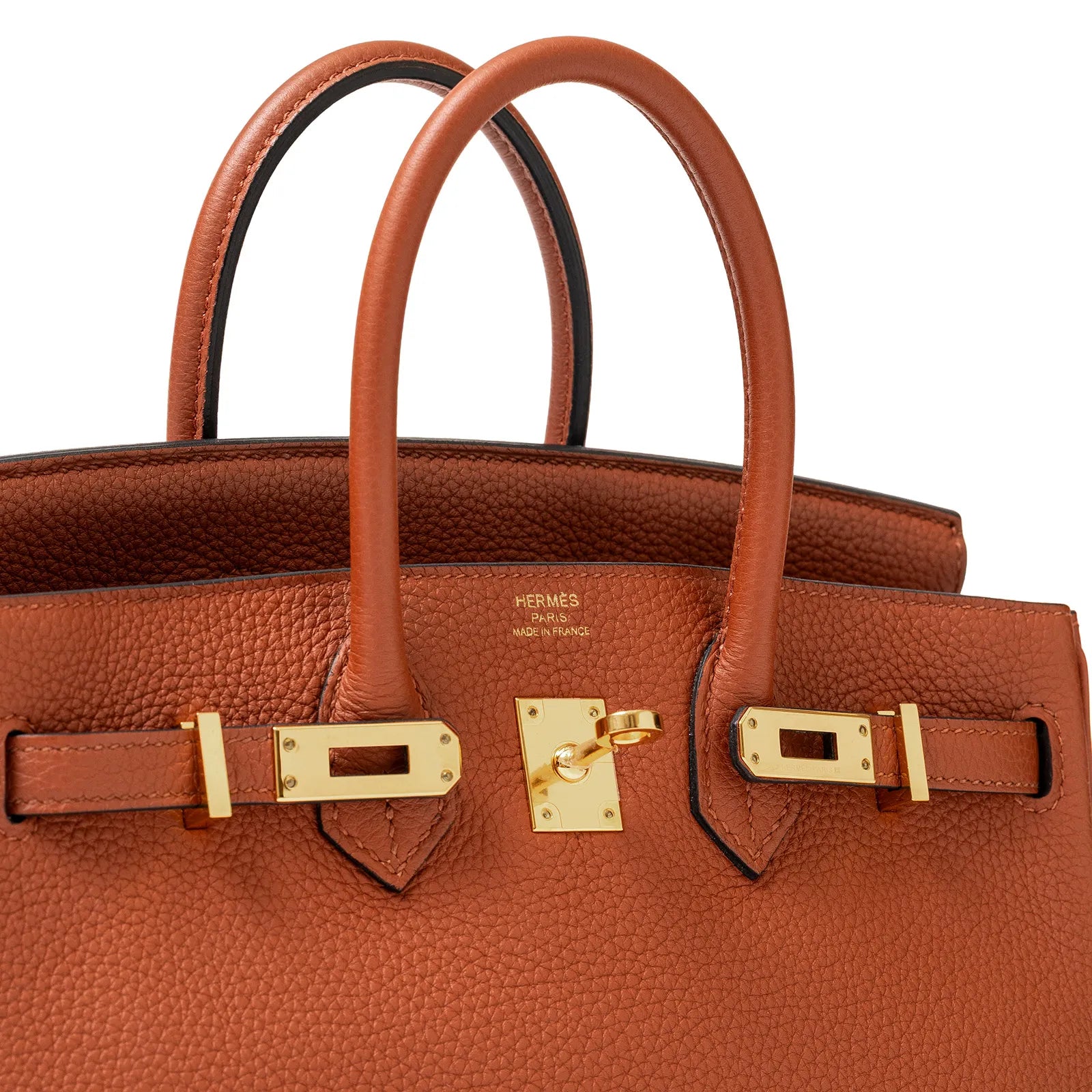 Close-up angled view of Hermès Birkin 25 in cuivre togo leather with gold tone hardware and rolled handles