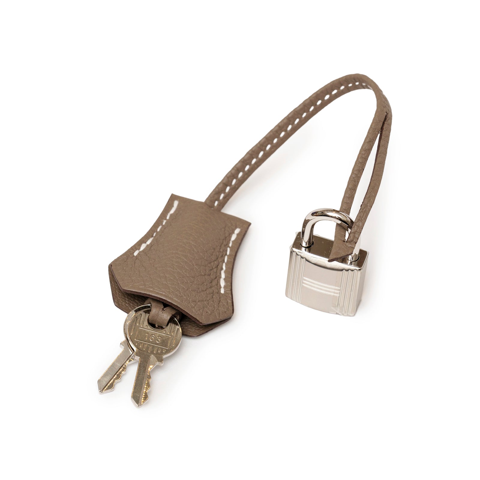 Close-up of Hermès Birkin 25 Etoupe Togo Palladium Hardware leather key holder with silver lock and two keys