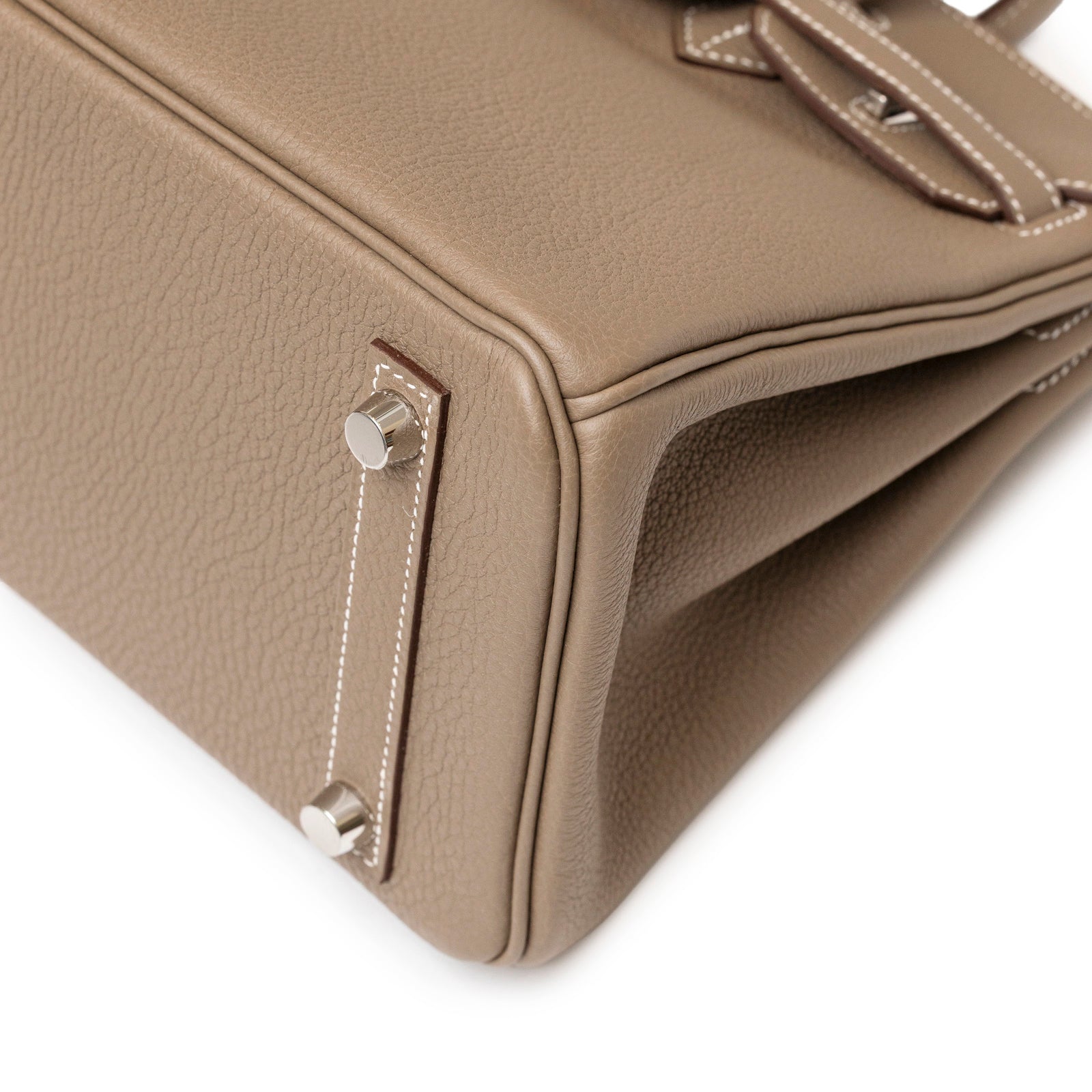 Close-up angled view of Hermès Birkin 25 Etoupe Togo Palladium Hardware showing stitching and metal feet detail