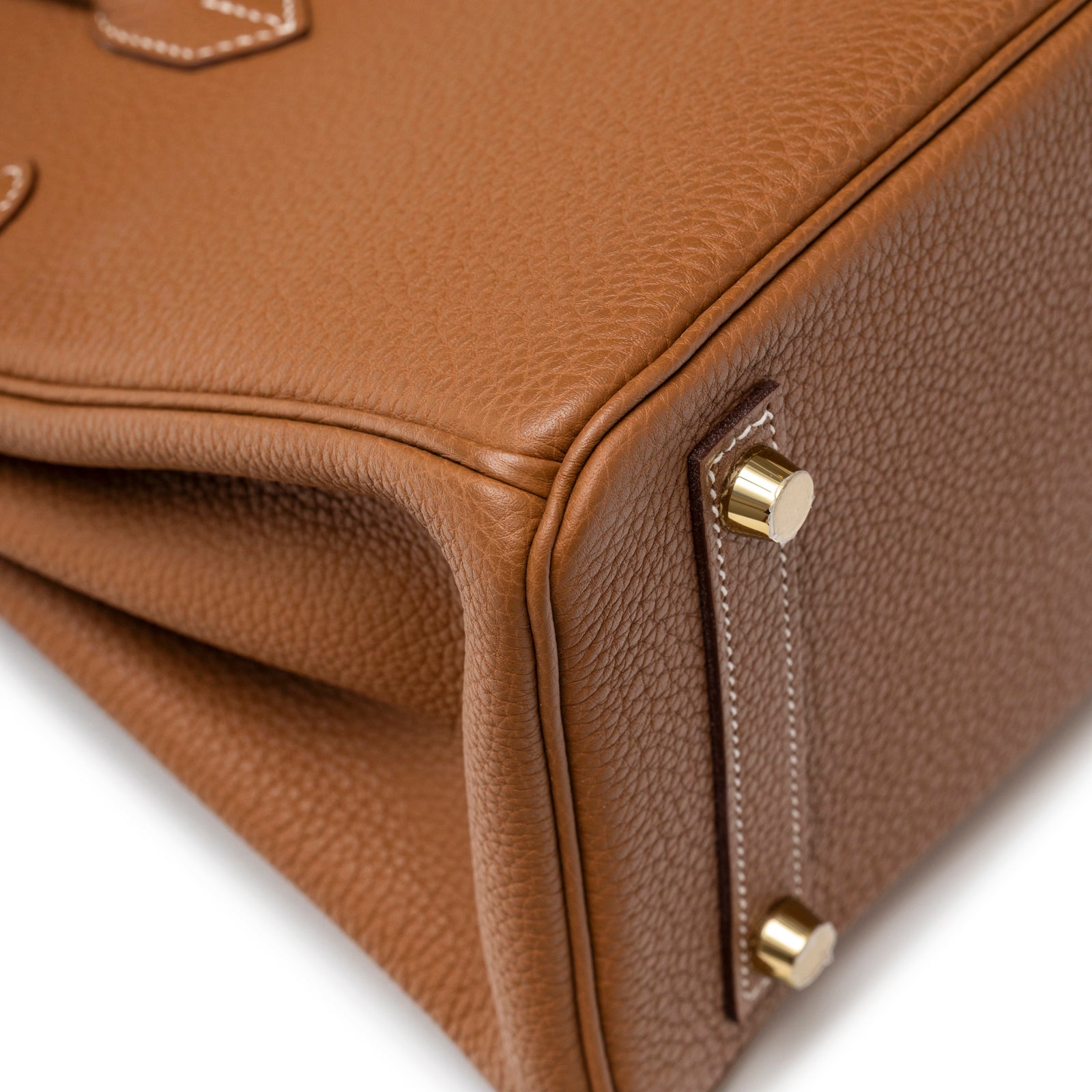 Close-up of Hermès Birkin 25 Gold Togo Gold Hardware corner showing dual-tone leather and gold feet details
